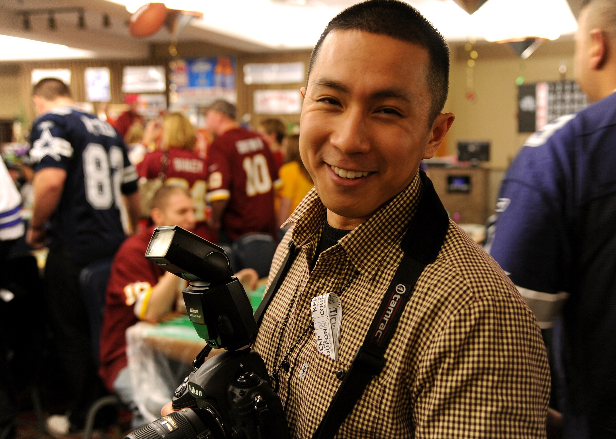 Senior Airman Xavier Navarro, 319th Air Base Wing Public Affairs Office, was the photographer for Super Bowl Extravaganza Jan. 19, 2013, at the Northern Lights Club on Grand Forks Air Force Base, N.D. The Dover, Del., transplant won second place in Air Mobility Command’s 2012 Media Contest in the category of Outstanding New Photographer. (U.S. Air Force photo/Airman 1st Class Zachiah Roberson)