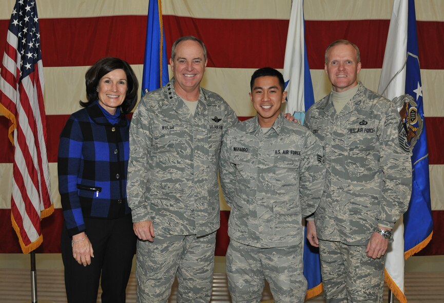 Senior Airman Xavier Navarro finds himself in front of the camera for a change while posing for a group photo with Air Force Chief of Staff Gen. Mark A. Welsh III, his wife, Betty, and Chief Master Sgt. of the Air Force James A. Cody on Nov. 25, 2013, at Grand Forks Air Force Base, N.D. The photo journalist from the 319th Air Base Wing Public Affairs Office, has served as the official base photographer during official Air Force events involving prominent Air Force senior leaders such as the Gen. Welsh and Gen.  Paul Selva the commander of Air Mobility Command.  (U.S. Air Force photo)