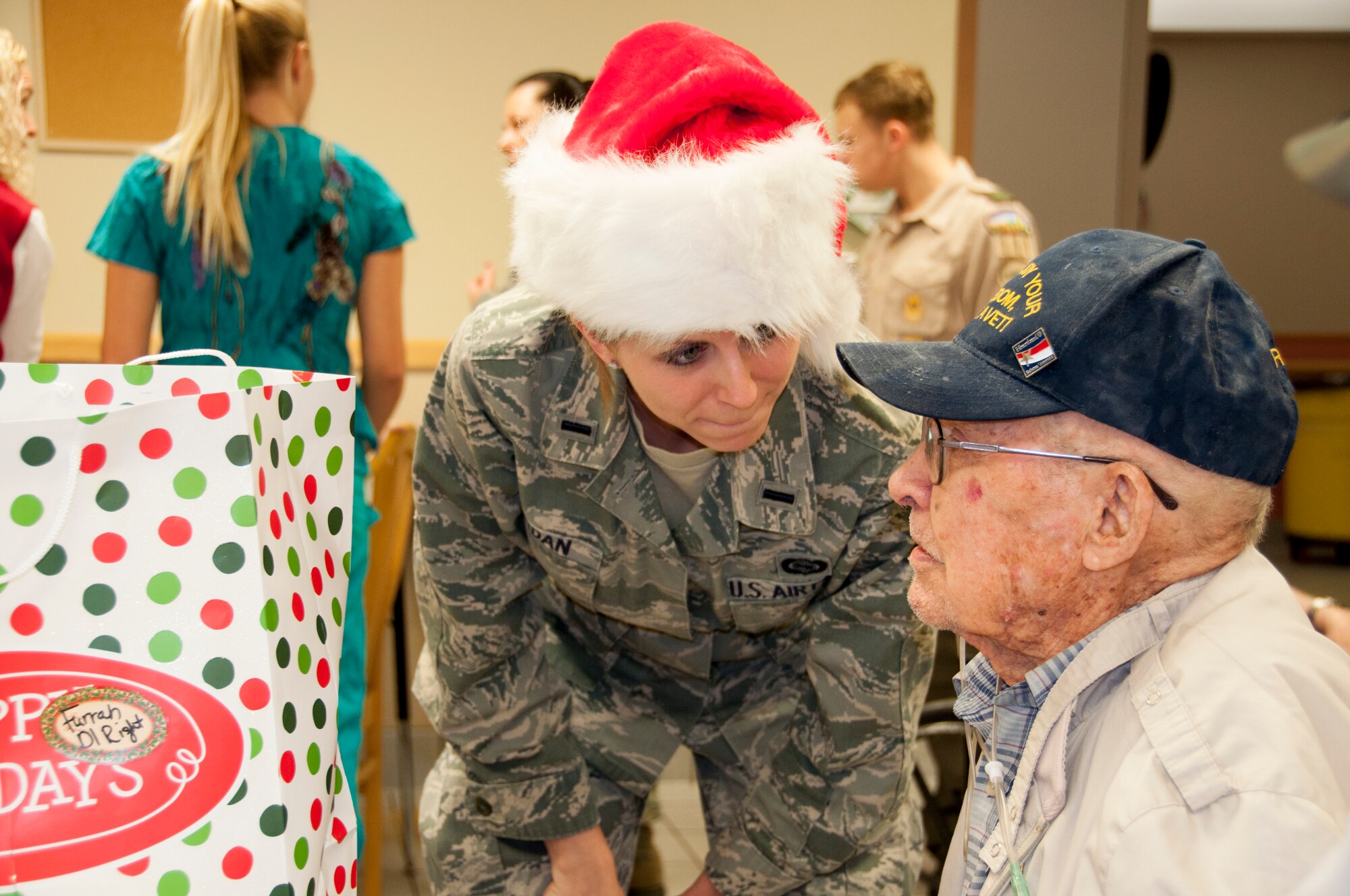 First Lieutenant Cristi Jordan, 507th Operations Group, listens to a veteran during the Norman Veterans Center Annual Christmas party, Dec. 23.  (U.S. Air Force Photo/Senior Airman Mark Hybers)