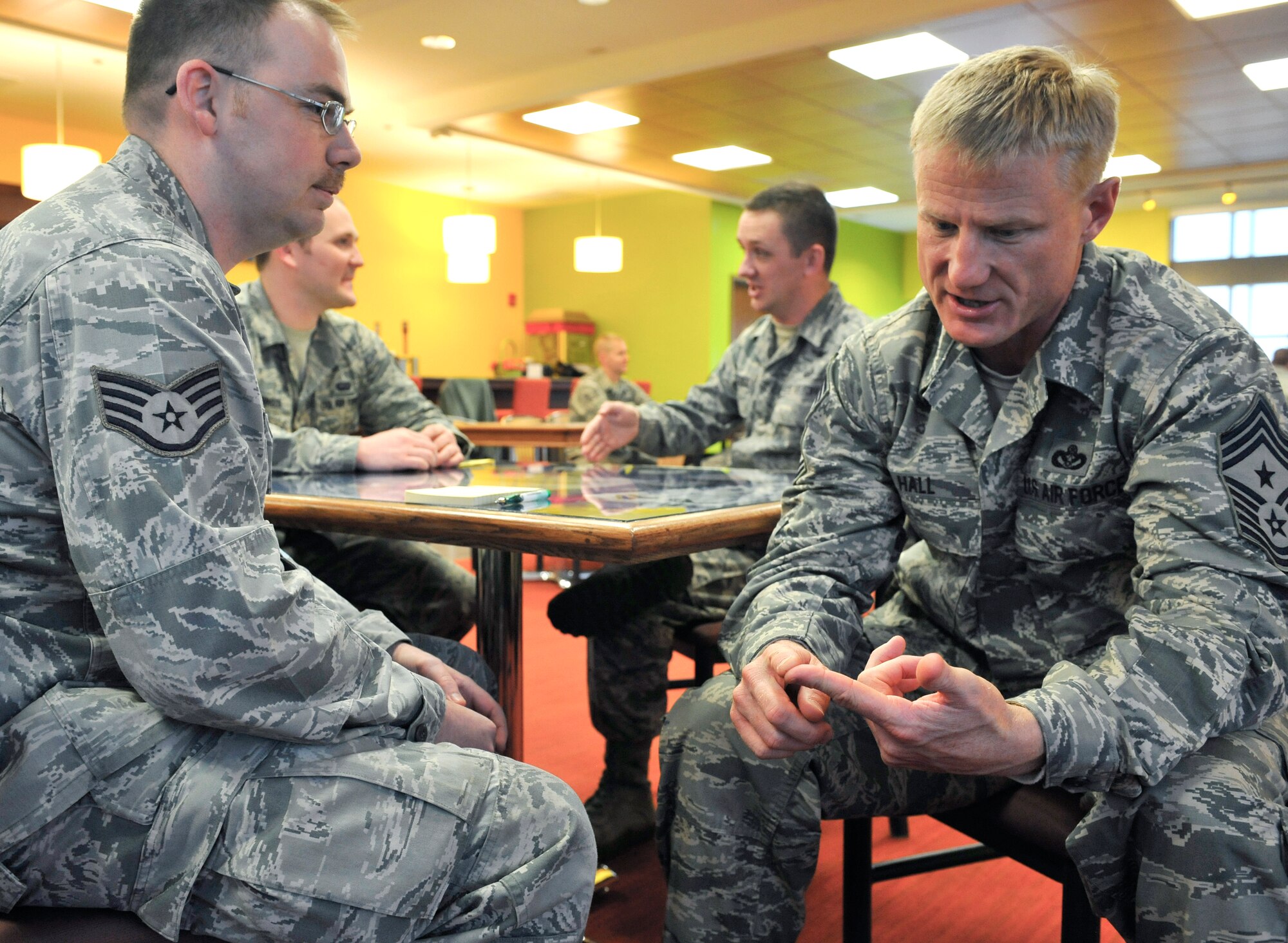 Chief Master Sgt. Craig S. Hall, 460th Space Wing command chief, gives advice to Staff  Sgt. Clay Goudeau Jr., Air Reserve Personnel Center, at Buckley’s speed mentoring Dec. 20, 2013, at Panther Den on Buckley Air Force Base, Colo. The event provided middle-enlisted members seeking advice and career guidance the ability to speak with Top 3 members from a variety of career fields. (U.S. Air Force photo by Airman 1st Class Samantha Saulsbury/Released)