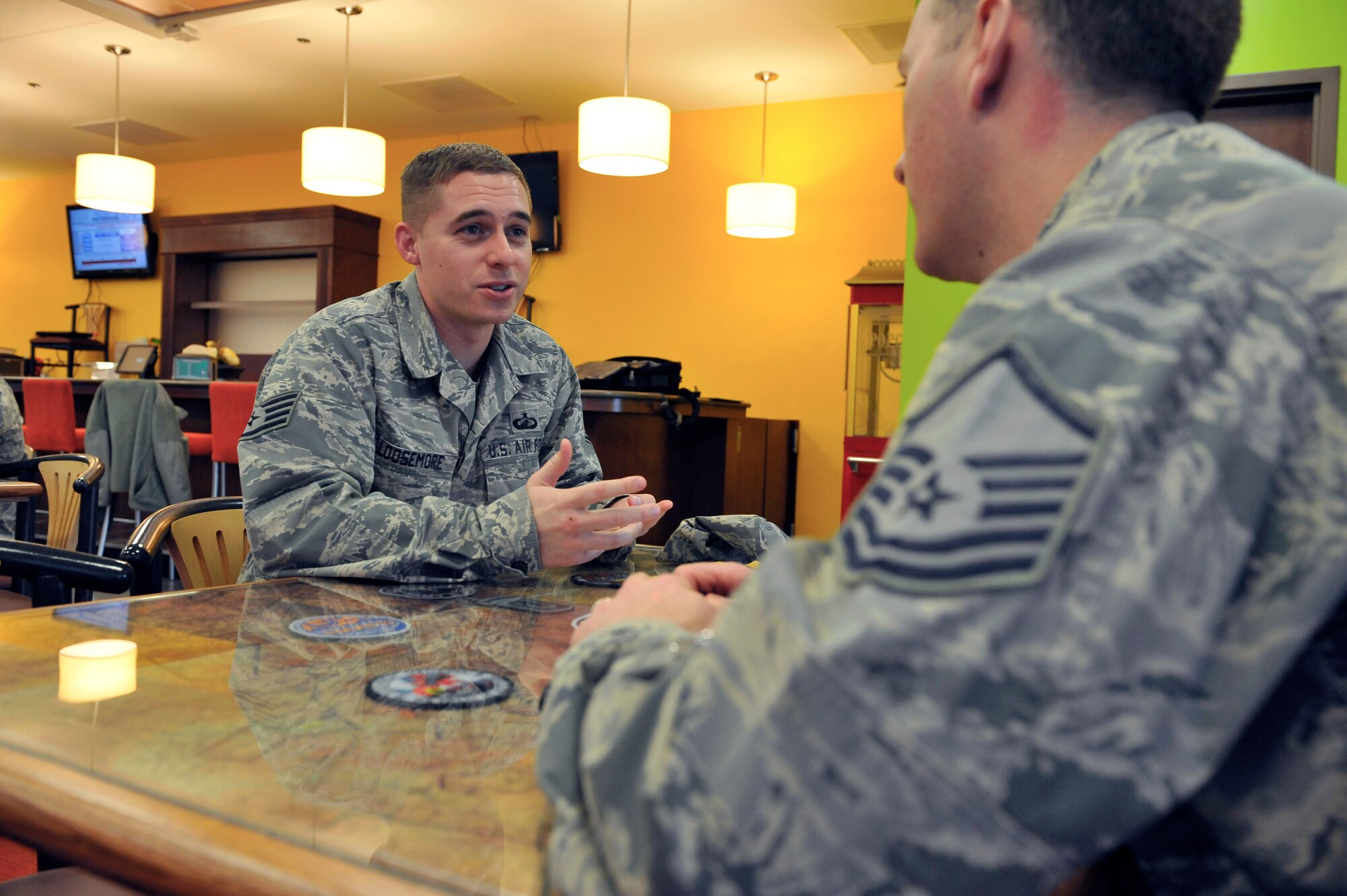 Staff Sgt. Arthur Loosemore, 460th Comptroller Squadron, receives advice from a master sergeant during Buckley’s speed mentoring event Dec. 20, 2013, at Panther Den on Buckley Air Force Base, Colo.  The opportunity provided middle-enlisted members seeking advice and career guidance the ability to speak with Top 3 members from a variety of career fields. (U.S. Air Force photo by Airman 1st Class Samantha Saulsbury/Released)