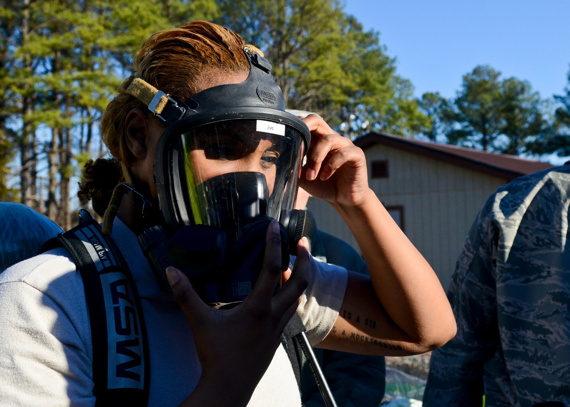 U.S. Air Force Staff Sgt. Jasmine Clemons, 633rd Aerospace Medicine Squadron bioenvironmental engineering technician, puts on her gas mask during a hazardous material exercise at Langley Air Force Base, Va., Dec. 18, 2013. The HAZMAT exercise tested the teams’ reaction and accuracy to a chemical emergency. Clemons hails from Los Angeles, Calif. (U.S. Air Force photo by Airman 1st Class Victoria H. Taylor/Released)