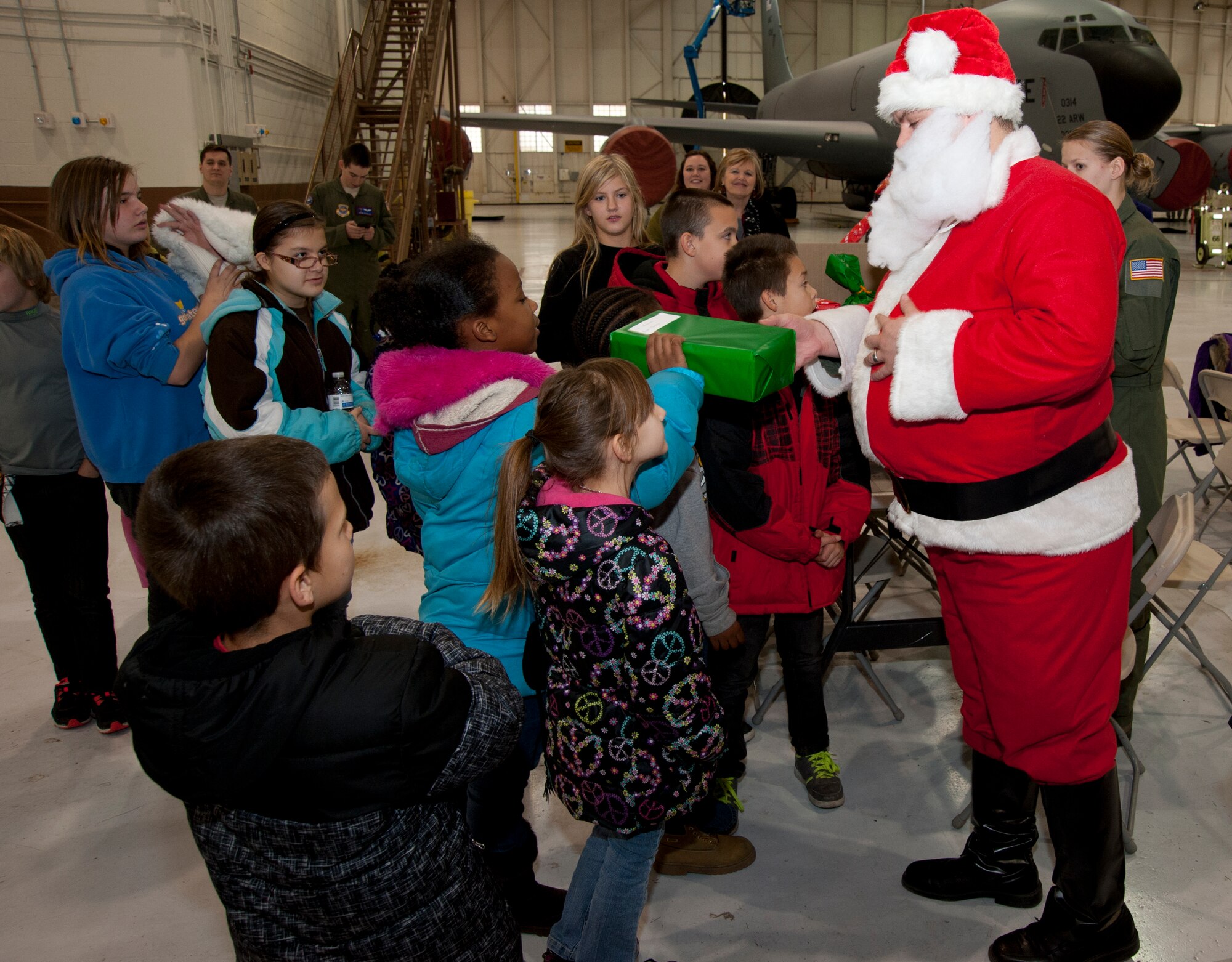 Children receive toys from "Santa" Dec. 20, 2013, at McConnell Air Force Base, Kan. The 349th Air Refueling Squadron hosted 18 children from Big Brothers Big Sisters Wichita on base for the annual Operation Santa tour. (U.S. Air Force photo/Airman 1st Class Victor J. Caputo)