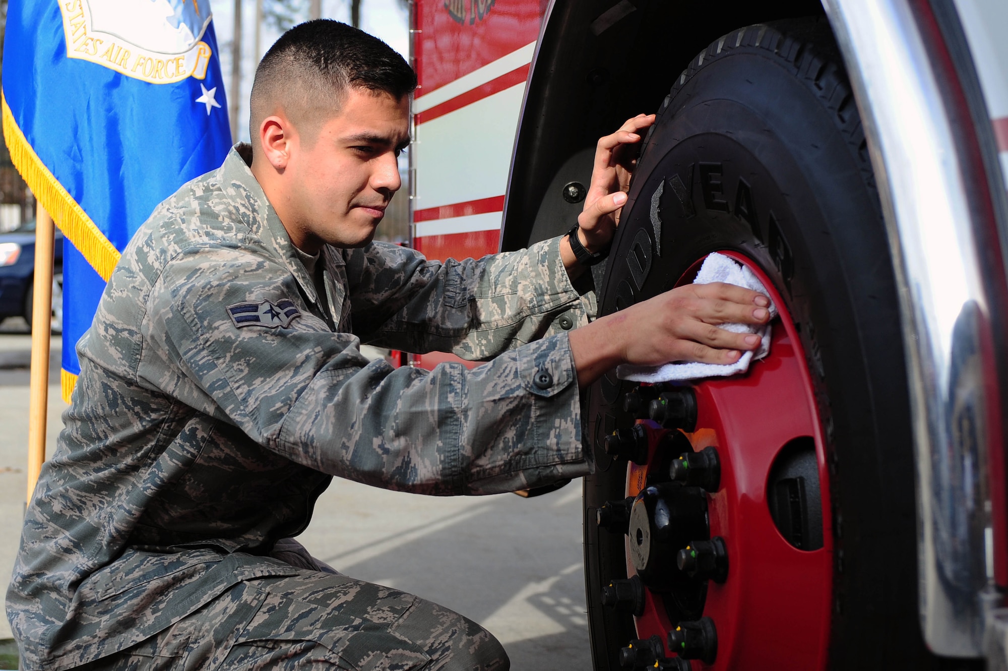 Airman 1st Class Ethan Salgado, 4th Civil Engineer Squadron fire fighter, polishes a wheel on a new fire truck at Seymour Johnson Air Force Base, N.C., Dec. 20, 2013. The base fire department’s new truck, Engine Four, replaced Engine Eight after 17 years of service in the station. (U.S. Air Force photo by Senior Airman John Nieves Camacho)