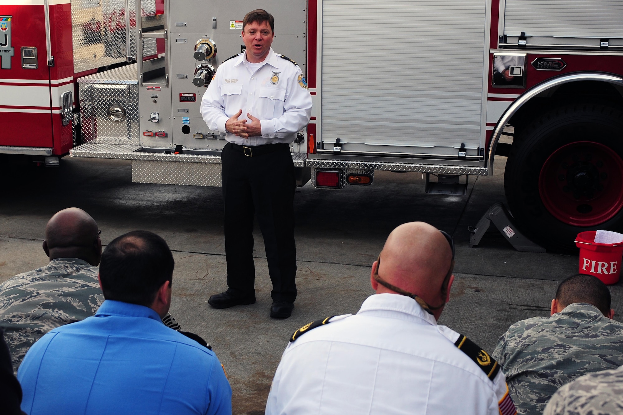 Sean Quinby, 4th Civil Engineer Squadron fire emergency services flight chief, gives opening remarks during the fire truck housing event at Seymour Johnson Air Force Base, N.C., Dec. 20, 2013. More than 30 members came to bear witness to the unveiling of the base fire department’s newest fire truck. (U.S. Air Force photo by Senior Airman John Nieves Camacho)