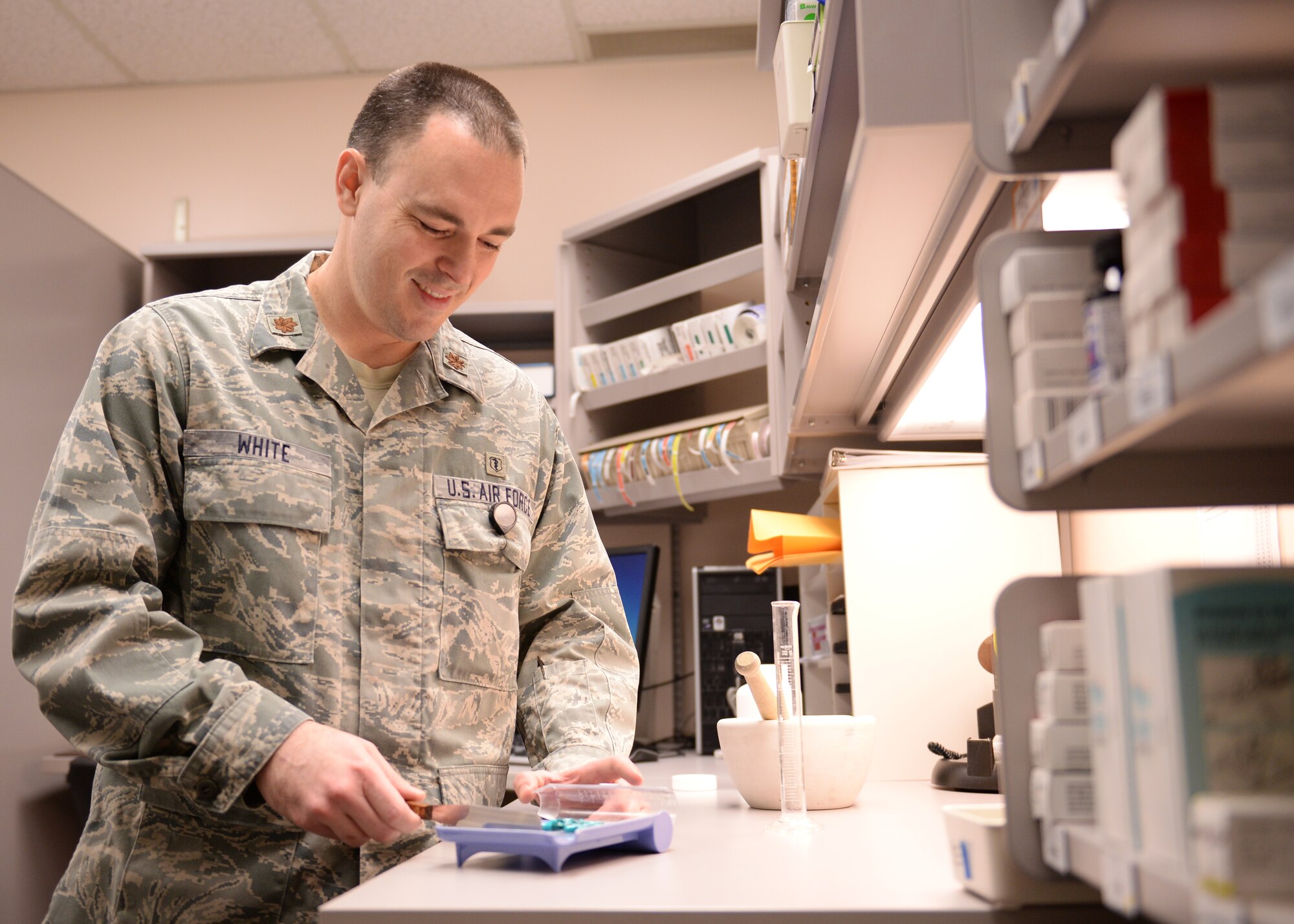 Maj. Shaun White, 354th Medical Support Squadron pharmacy and radiology flight commander, sorts prescription pills Dec. 19, 2013, Eielson Air Force Base, Alaska. White recently received Pacific Air Force’s Biomedical Specialist Category I Company Grade Officer of the Year Award. (U.S. Air Force photo by Airman 1st Class Peter Reft/Released)