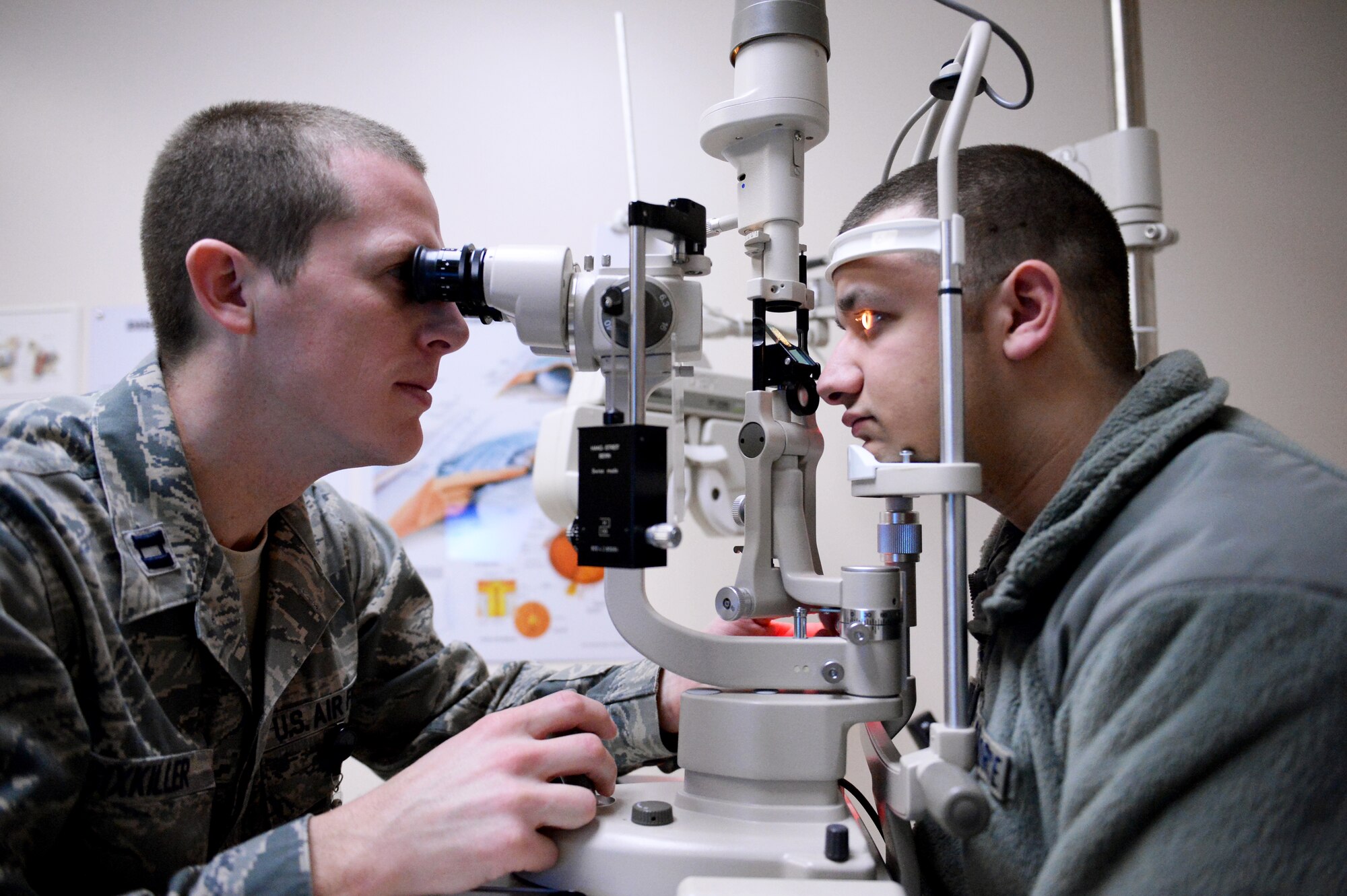 Capt. Bryan Sixkiller, 354th Medical Operations Squadron optometry element leader, performs an eye test on Senior Airman Charlie Brown, 354th Logistics Readiness Squadron vehicle operator, Dec. 19, 2013, Eielson Air Force Base, Alaska.  Sixkiller recently received Pacific Air Force’s Biomedical Clinician Category I Company Grade Officer of the Year Award. (U.S. Air Force photo by Airman 1st Class Peter Reft/Released) 