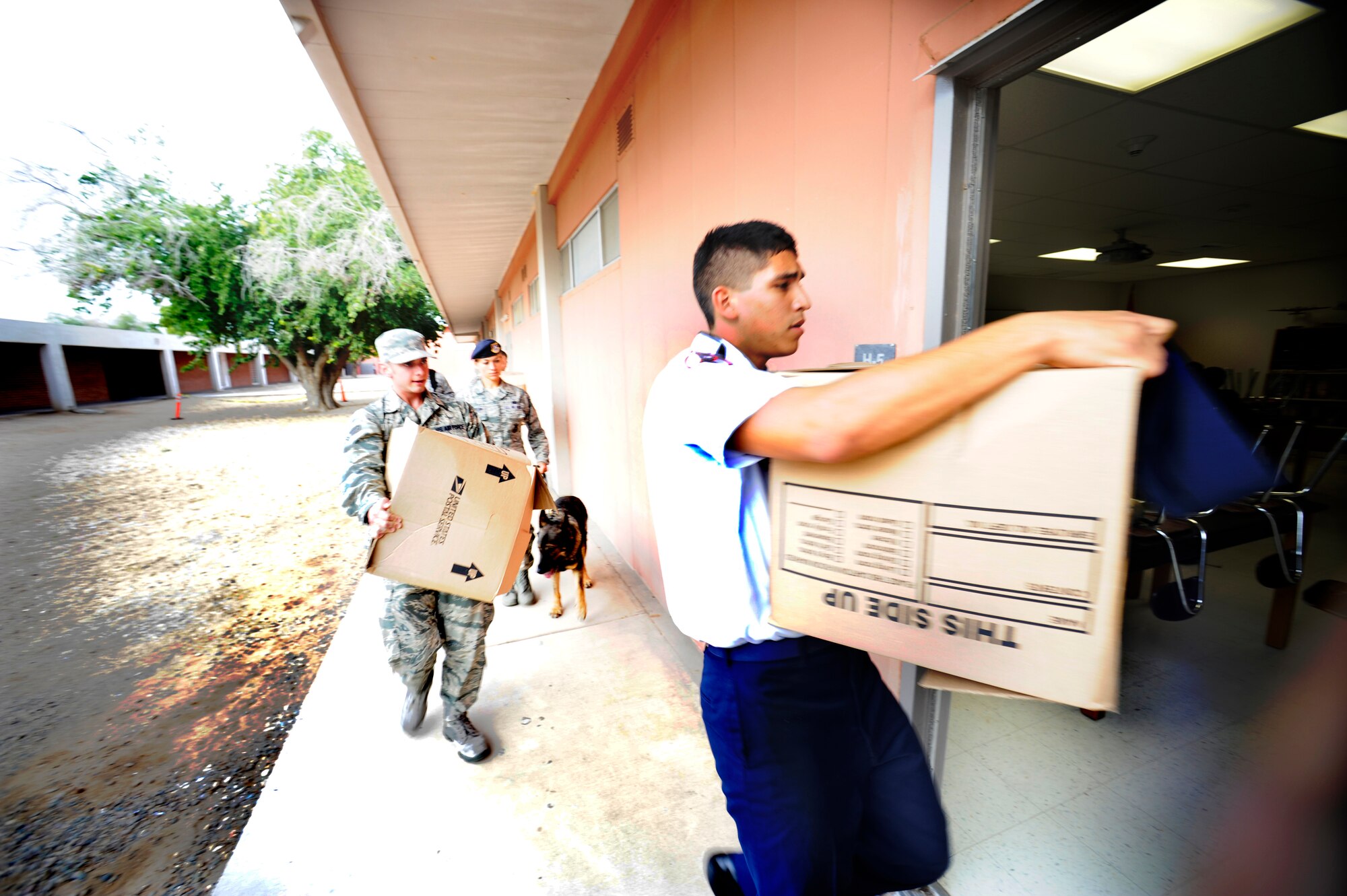 Agua Fria Junior ROTC Group Cadets and Luke Air Force Base Airmen bring boxes of uniforms to a classroom Dec. 4 at Agua Fria High School in Avondale.  The 56th Equipment Maintenance Squadron unit advisory council held a drive to acquire gently used ABUs, Battle Dress Uniforms and boots, collecting more than 84 individual pieces. (U.S. Air Force photo/Senior Airman Jason Colbert)