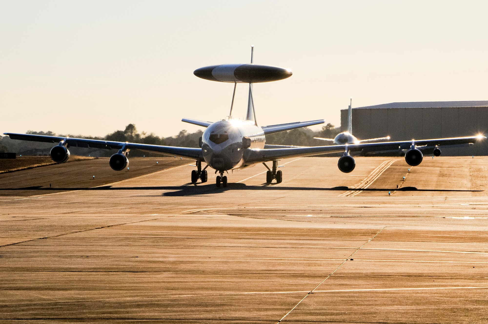 An E-3 Sentry AWACS taxis in after a mission with an E-8C Joint STARS following close behind at Robins Air Force Base, Ga., Dec. 12, 2013. The AWACS aircraft along with RC-135 RIVETJOINT aircraft were at Robins to participate in a command and control (C2) joint force exercise with Team JSTARS. The three platforms, known as the Iron Triad, participated in the exercise to practice interoperability between multiple C2 platforms. (U.S. Air National Guard photos by Capt. Pamela Stauffer/Released)