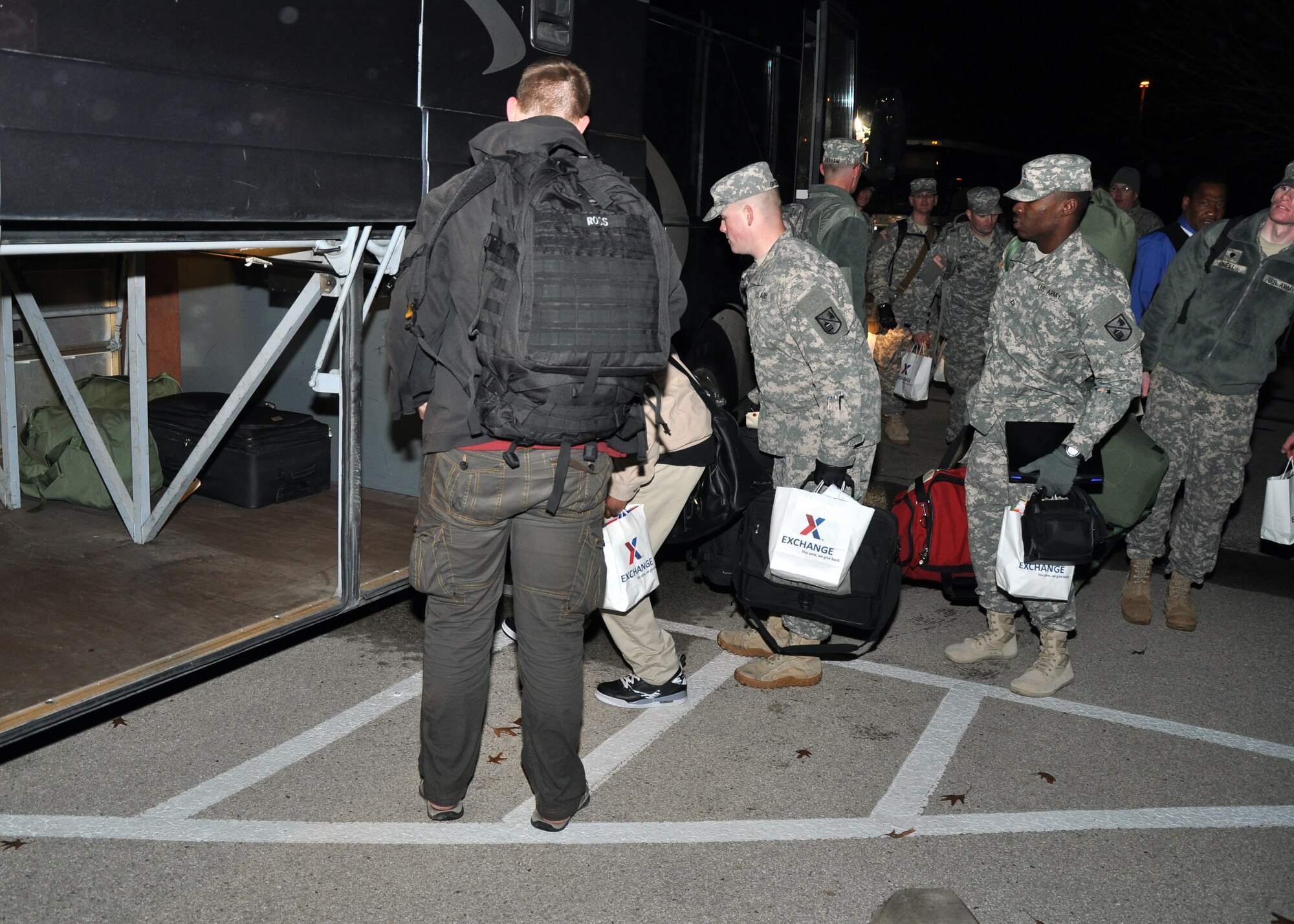 GOODFELLOW AIR FORCE BASE, Texas – Service members place their luggage in the storage compartment of a bus at the Carswell Field House parking lot before leaving for exodus Dec. 20. This was the first bus out of a dozen to leave for the Dallas-Fort Worth International Airport for the annual winter holiday. (U.S. Air Force photo/ Senior Airman Joshua Edwards)