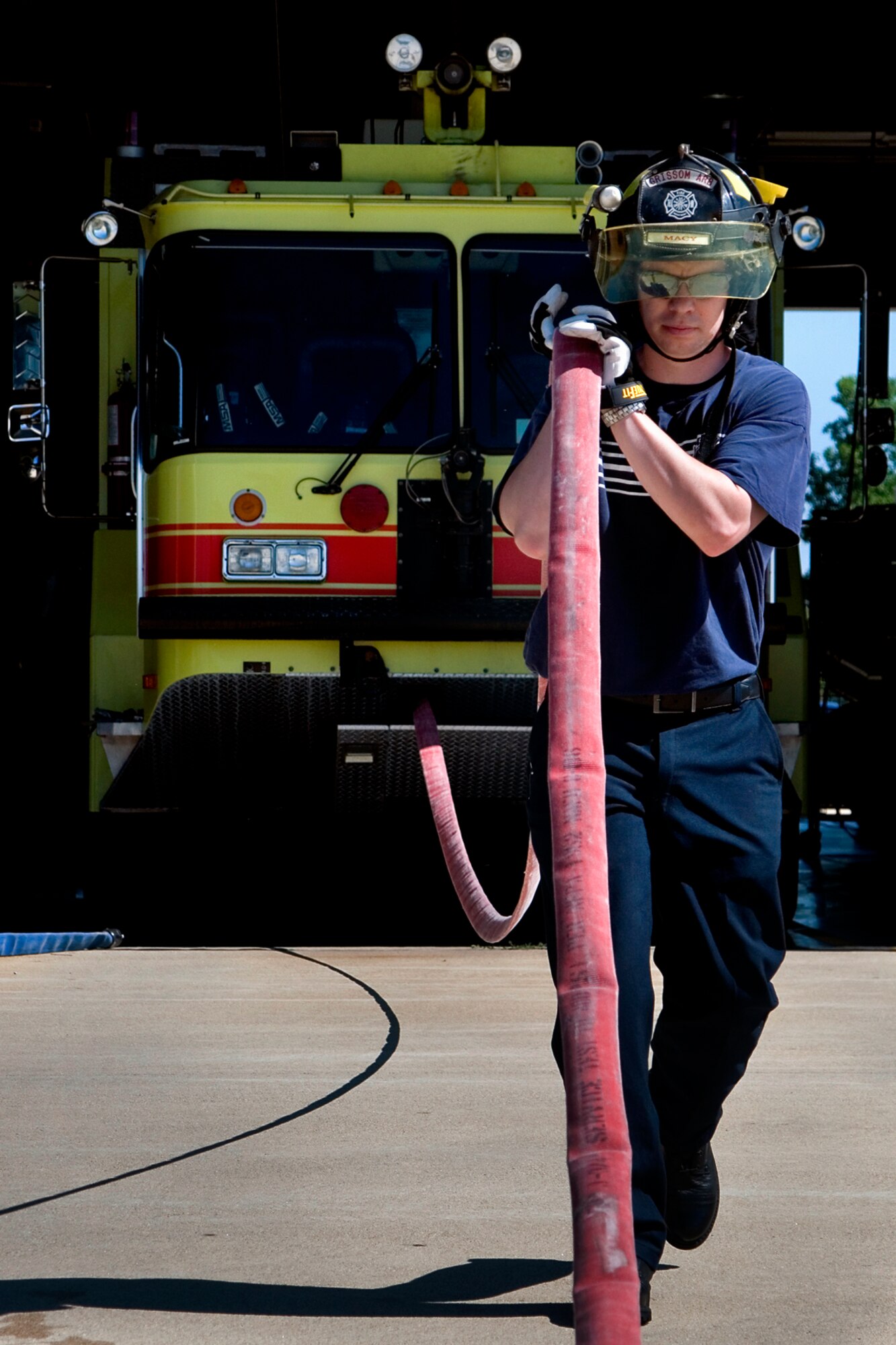 Curtis Macy, Grissom fire fighter, prepares a fire hose for pressure testing at Grissom Air Reserve Base, Ind., July 12, 2013. The Grissom Fire Department is comprised of both civilian and military reservist fire fighters, who work and train together to protect the base and the local community. (U.S. Air Force photo/Staff Sgt. Andrew McLaughlin)
