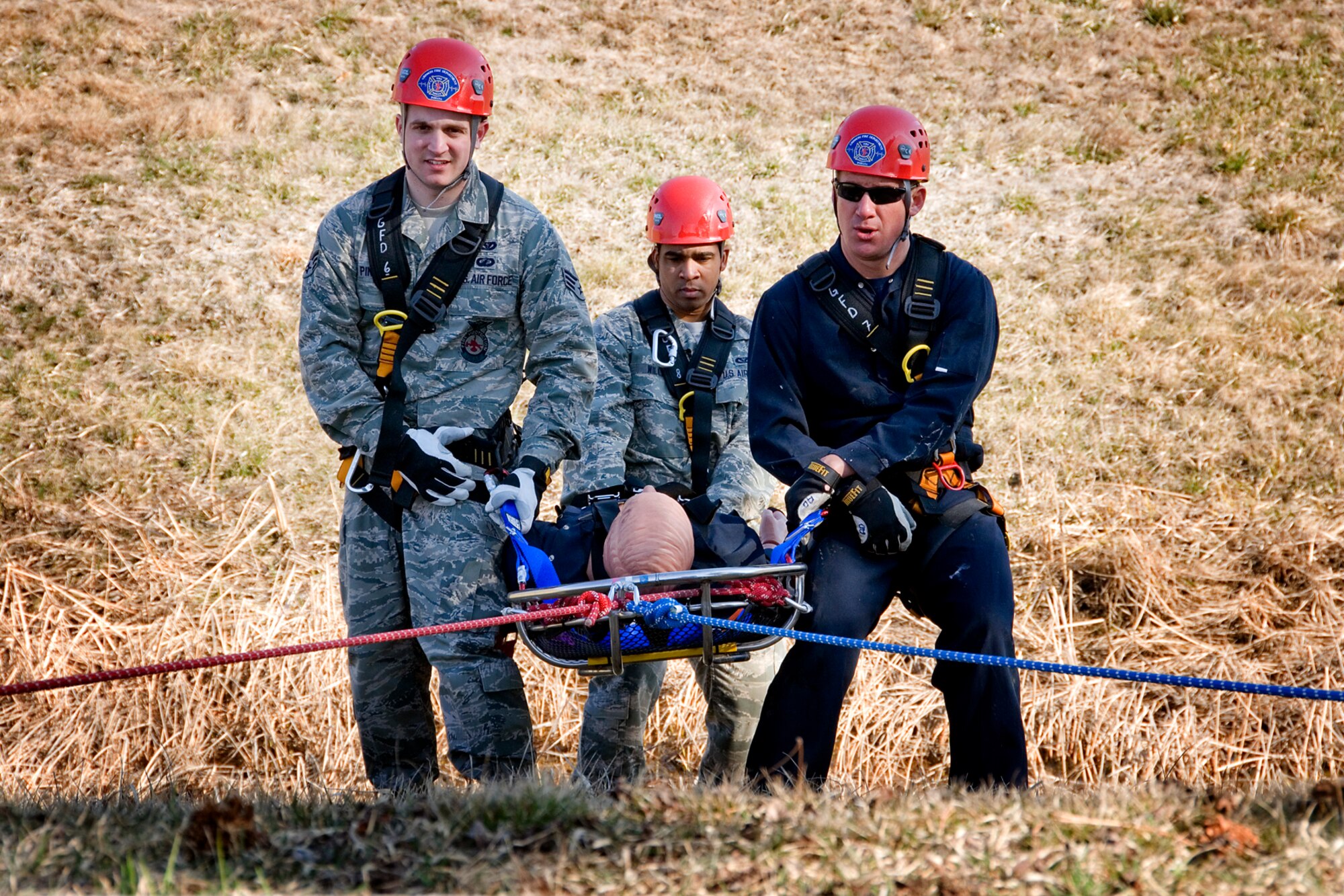 From the left, Airman Kenneth Pinnaire, Airman 1st Class Todd Williams, and Aaron Dehner, all Grissom firefighters, rescue an accident "victim" during a training scenario at Grissom Air Reserve Base, Ind., April 5, 2013. Civilian and military firefighters often train together. The Grissom Fire Department is comprised of both civilian and military reservist fire fighters, who work and train together to protect the base and the local community. (U.S. Air Force photo/Tech. Sgt. Douglas Hays) 