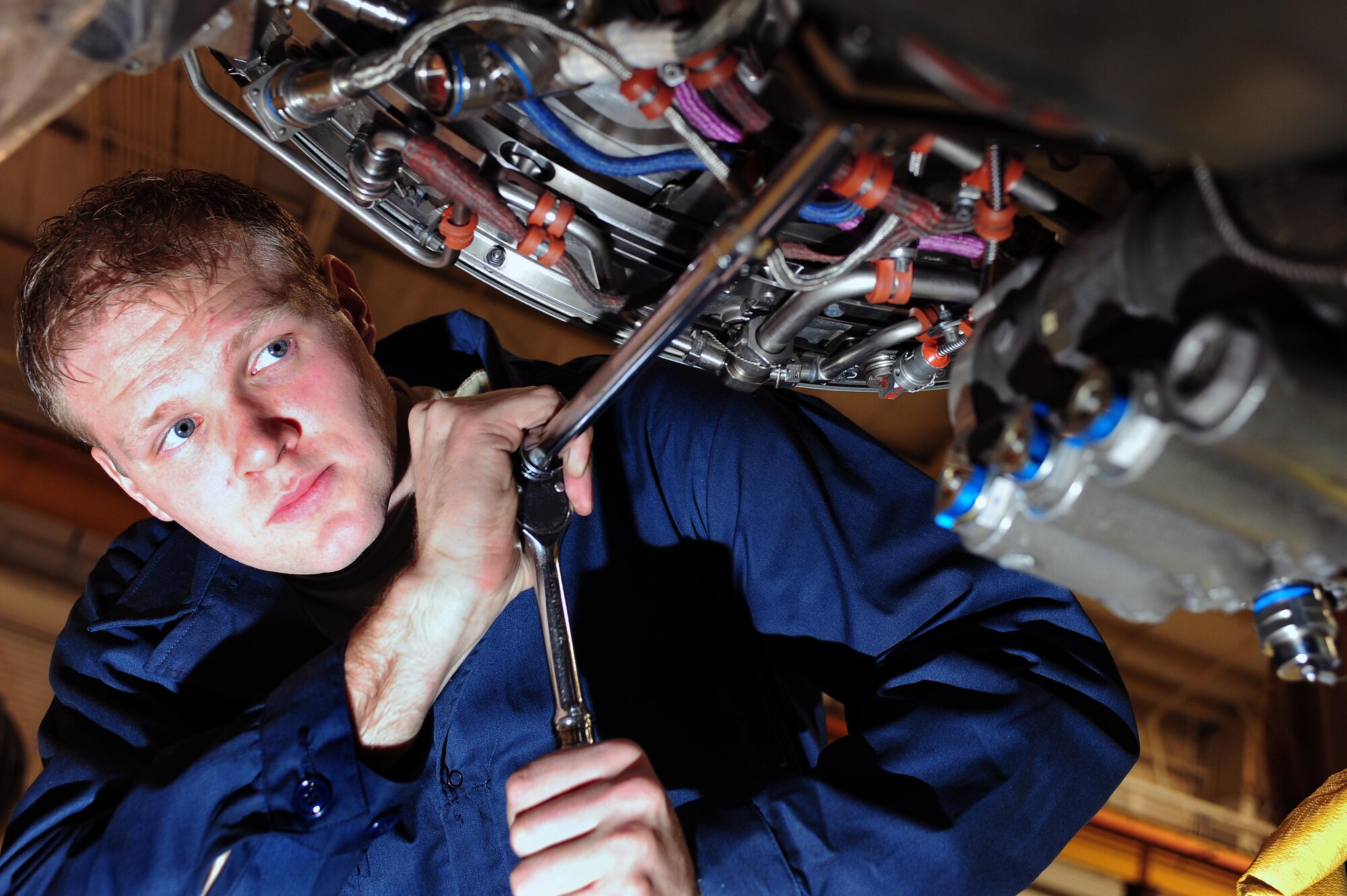 Airman 1st Class Tyler Wentworth, 4th Component Maintenance Squadron aerospace propulsion specialist, services an F-15E Strike Eagle aircraft engine at Seymour Johnson Air Force Base, N.C., Dec. 19, 2013. Aerospace propulsion specialists are responsible for diagnosing, maintaining and repairing aircraft engines. (U.S. Air Force photo by Senior Airman John Nieves Camacho)