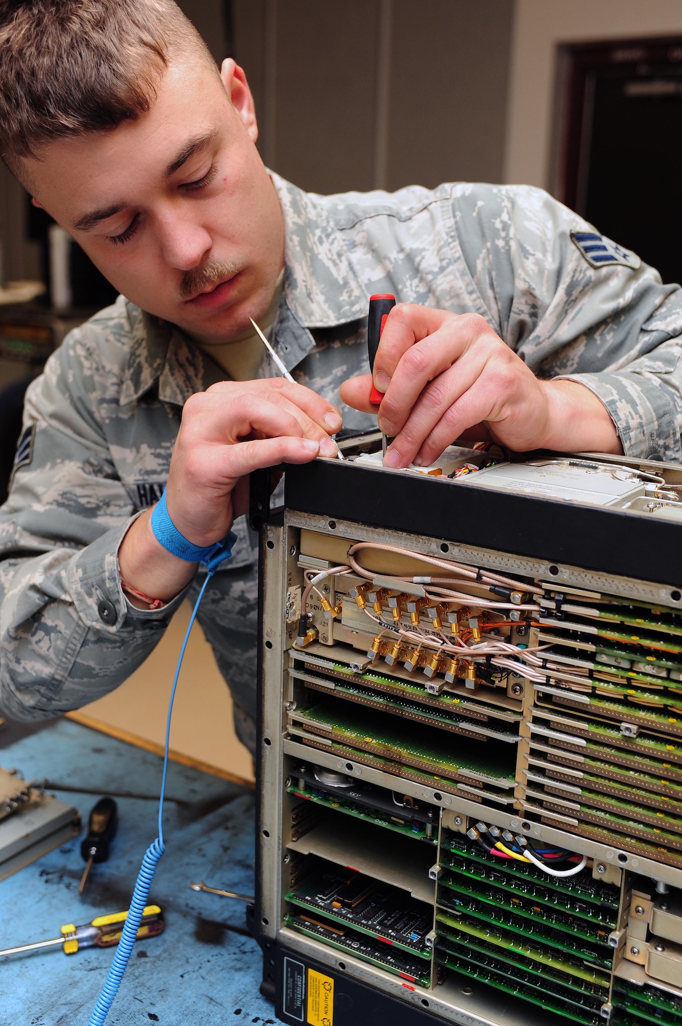 Senior Airman Glenn Hall, 4th Component Maintenance Squadron avionics technician, services an F-15E Strike Eagle aircraft countermeasure unit at Seymour Johnson Air Force Base, N.C., Dec. 19, 2013. Avionics technicians are responsible for maintaining and servicing multiple on-board aircraft systems to include navigation, communications and flight controls, to ensure combat and support aircraft are ready to go at a moment’s notice. (U.S. Air Force photo by Senior Airman John Nieves Camacho)