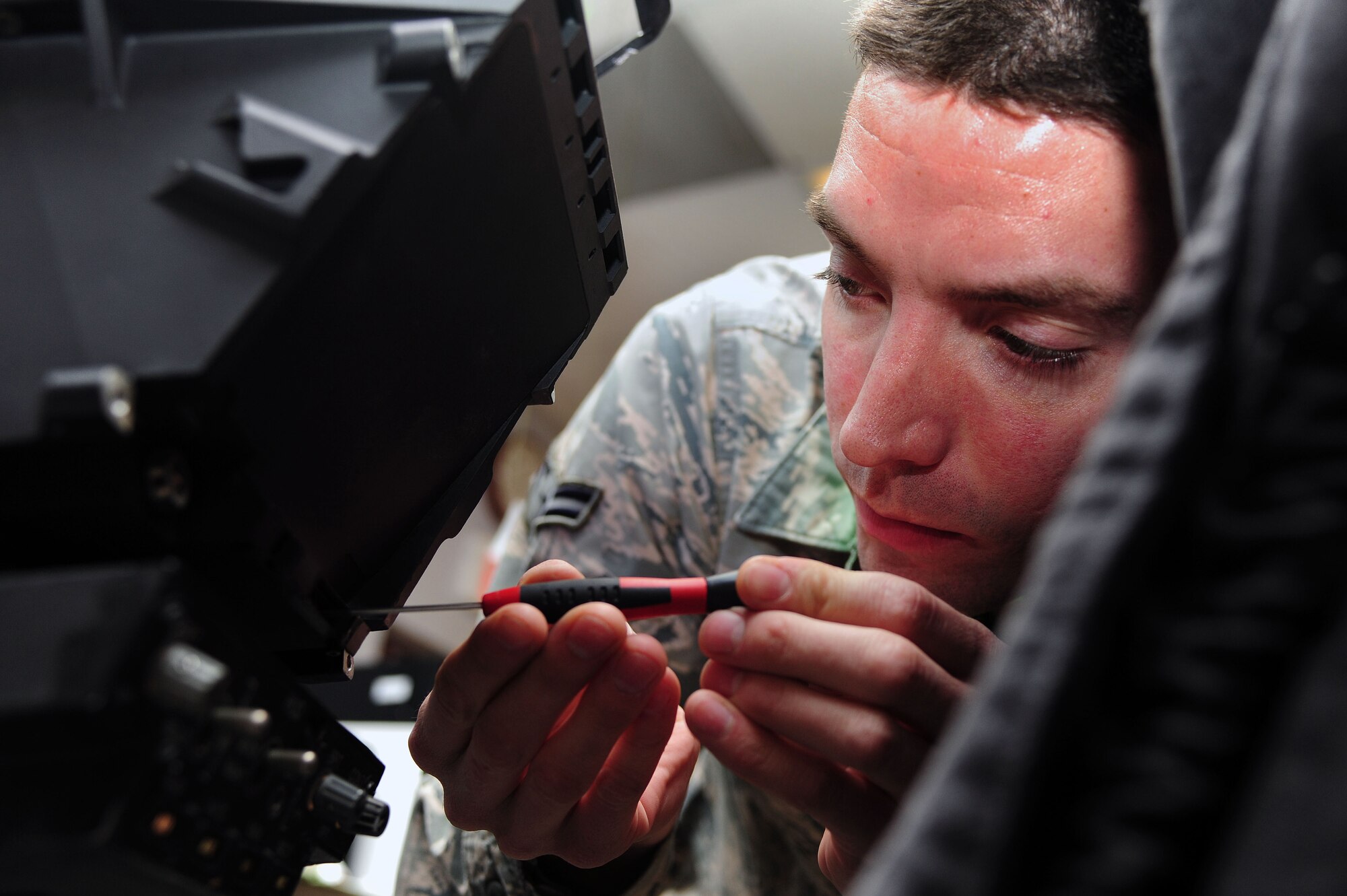 Airman 1st Class Luke Tenhopen, 4th Component Maintenance Squadron avionics technician, calibrates an F-15E Strike Eagle aircraft heads-up display (HUD) system at Seymour Johnson Air Force Base, N.C., Dec. 19, 2013. The HUD is a transparent display which shows pilots various aircraft data without having to look away from the path of flight. (U.S. Air Force photo by Senior Airman John Nieves Camacho)