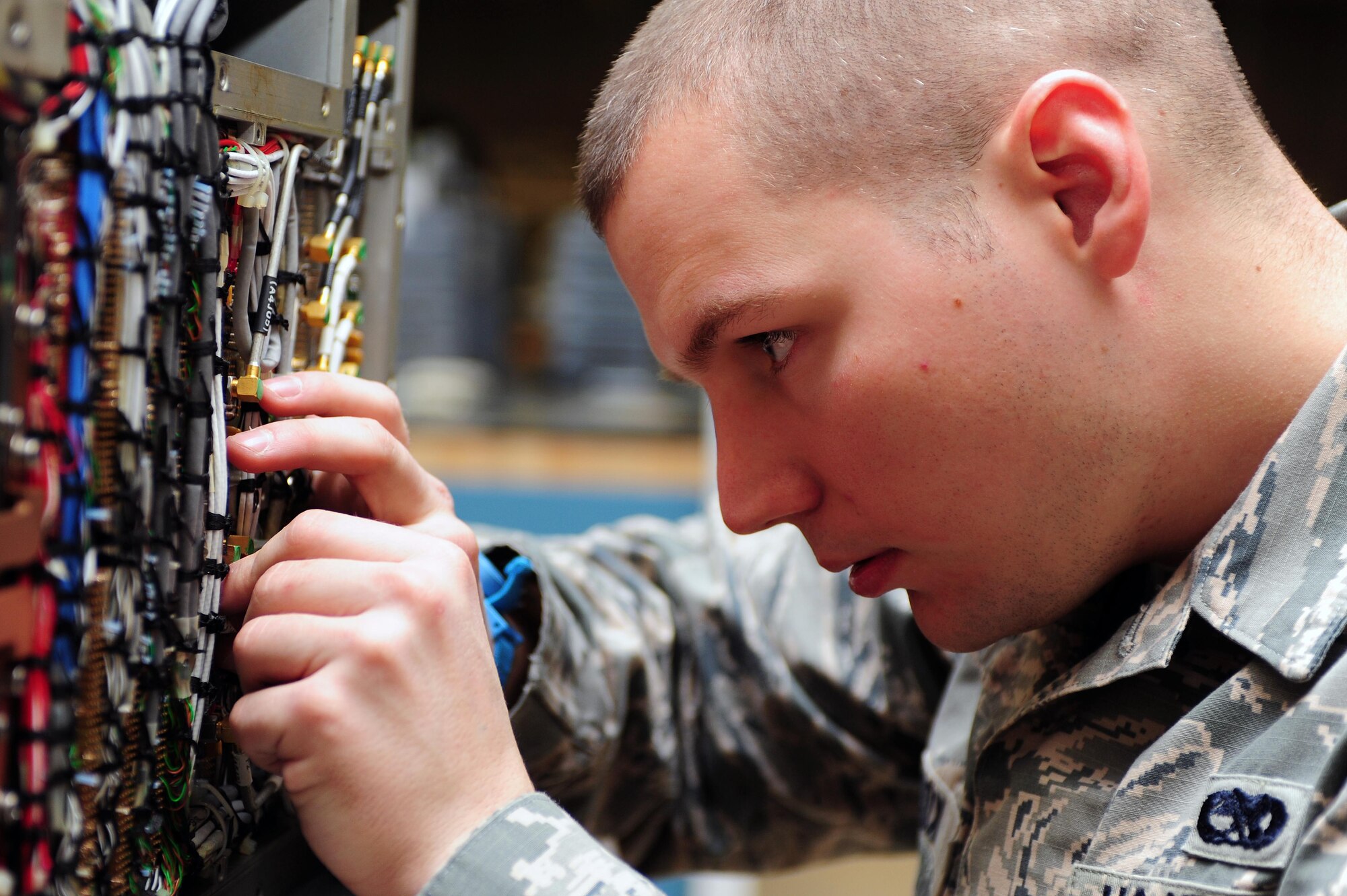 Senior Airman Kevin Cox, 4th Component Maintenance Squadron avionics technician, installs hardlines on an F-15E Strike Eagle aircraft radar system at Seymour Johnson Air Force Base, N.C., Dec. 19, 2013. Avionics technicians are responsible for maintaining and servicing multiple on-board aircraft systems to include navigation, communications and flight controls, to ensure combat and support aircraft are ready to go at a moment’s notice. (U.S. Air Force photo by Senior Airman John Nieves Camacho)