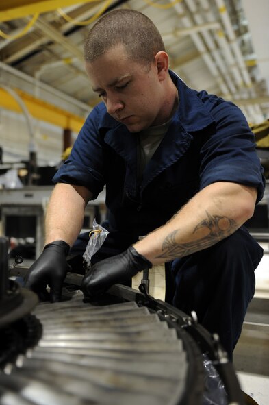 Staff Sgt. Richard Anderson, 4th Component Maintenance Squadron aerospace propulsion specialist, repairs a jet engine at Seymour Johnson Air Force Base, N.C., Dec. 19, 2013. The engine sustained damaged when foreign object debris came into contact with it. (U.S. Air Force photo by Airman 1st Class Aaron J. Jenne)