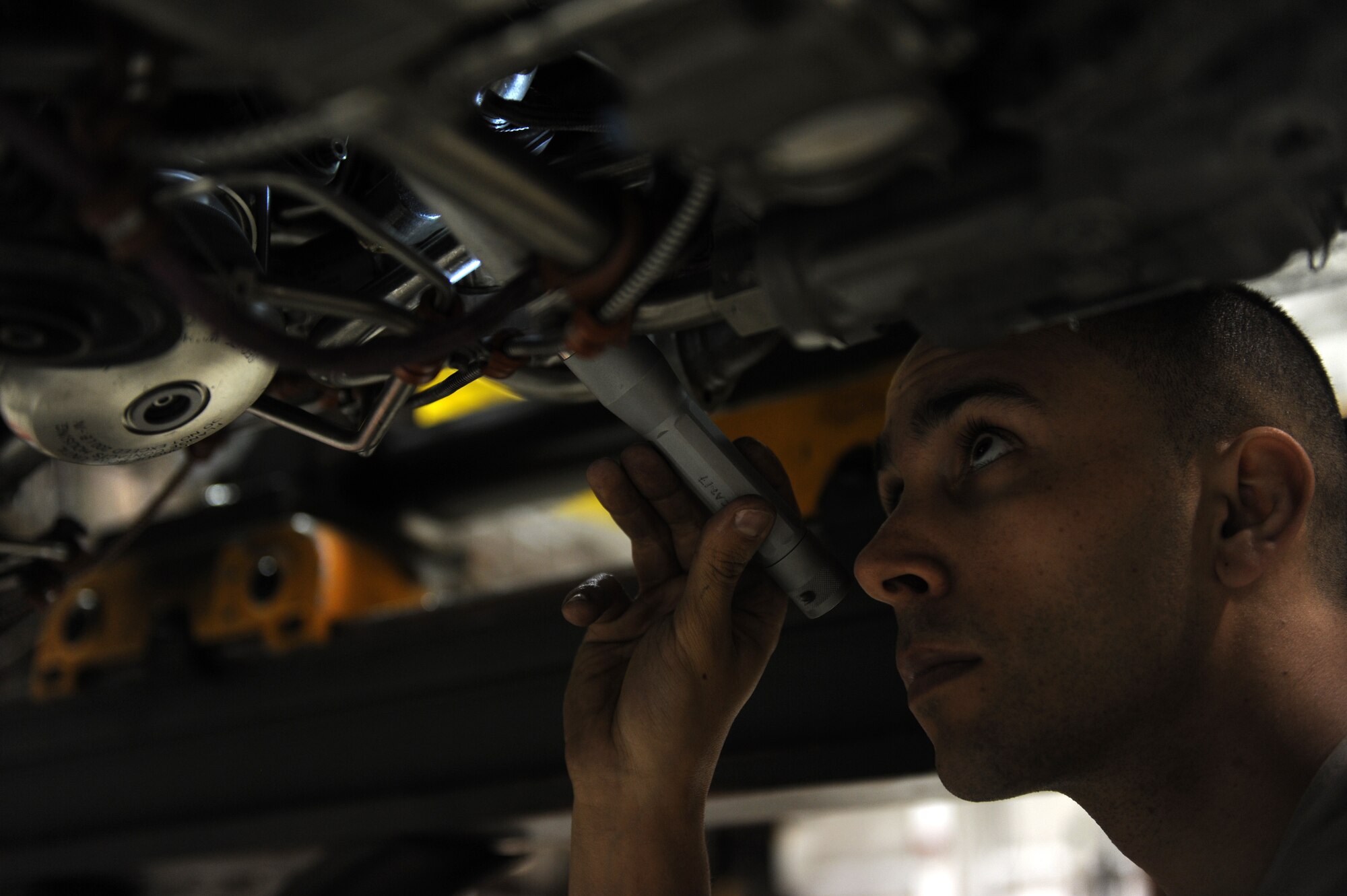 Senior Airman Justin Stringer, 4th Component Maintenance Squadron aerospace propulsion specialist, inspects a jet engine at Seymour Johnson Air Force Base, N.C., Dec. 19, 2013. Specialists inspect and repair aircraft engines to ensure they operate flawlessly in training exercises or combat operations. (U.S. Air Force photo by Airman 1st Class Aaron J. Jenne)