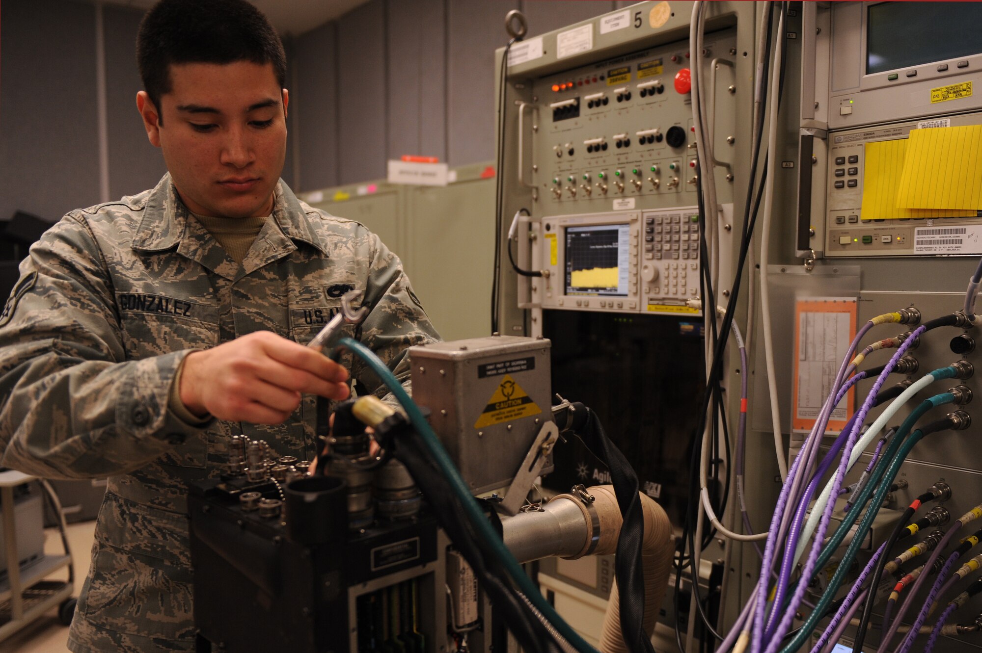 Airman 1st Class Jorge Gonzalez, 4th Component Maintenance Squadron avionics technician, removes an F-15E Strike Eagle high-band frequency receiver from a testing station at Seymour Johnson Air Force Base, N.C., Dec. 19, 2013. High band frequency receivers convert radio waves into usable information for aircrew operations. (U.S. Air Force photo by Airman 1st Class Aaron J. Jenne)