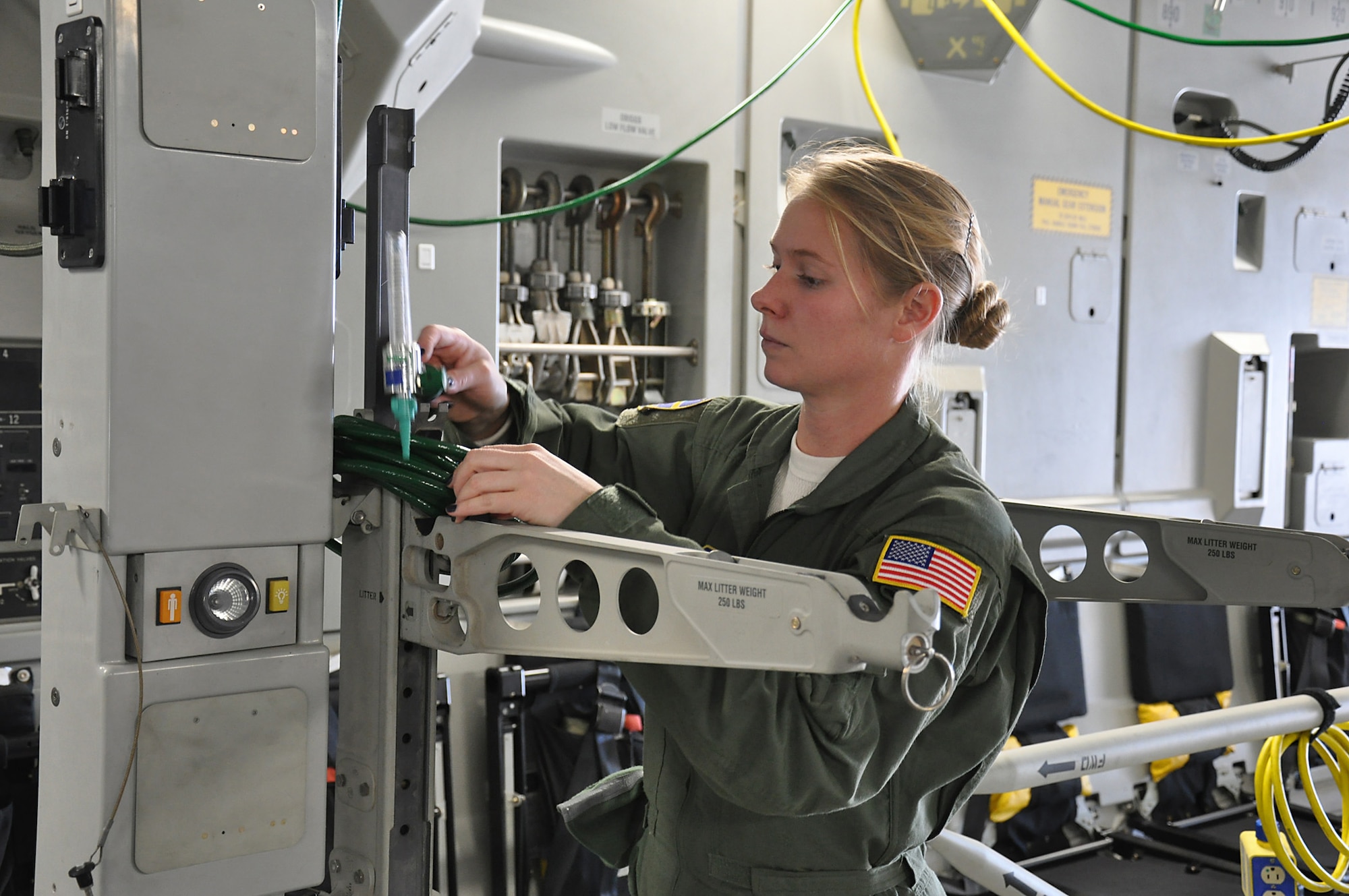 Tech. Sgt. Michelle Geers, an aeromedical evacuation technician assigned to the 315th Aeromedical Evacuation Squadron at Joint Base Charleston, S.C., prepares her equipment during a training mission.  Members of the 315 AES conducted training aboard a C-17 Globemaster III aircraft en route to Incirlik Air Base, Turkey Dec. 19, 2013. (U.S. Air Force photo by Senior Airman Bobby Pilch/released) 