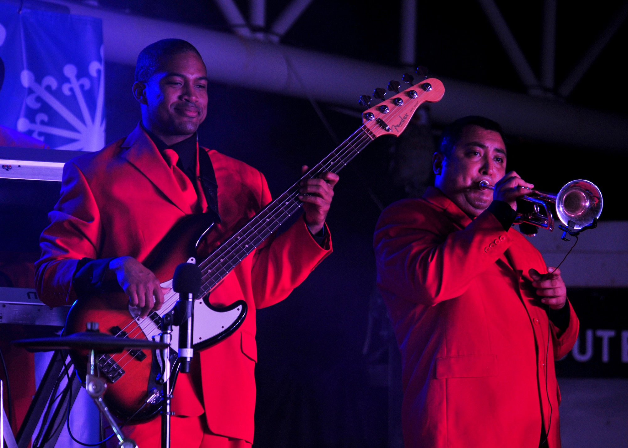 Air Force Senior Airman Samuel Underwood, bassist, and Melisio Garcia, trumpeter, perform in the 'Gift of Music' tour for members of the 380th Air Expeditionary Wing at an undisclosed location in Southwest Asia, Dec. 19, 2013. (U.S. Air Force photo by Staff Sgt. Michael Means/Released)