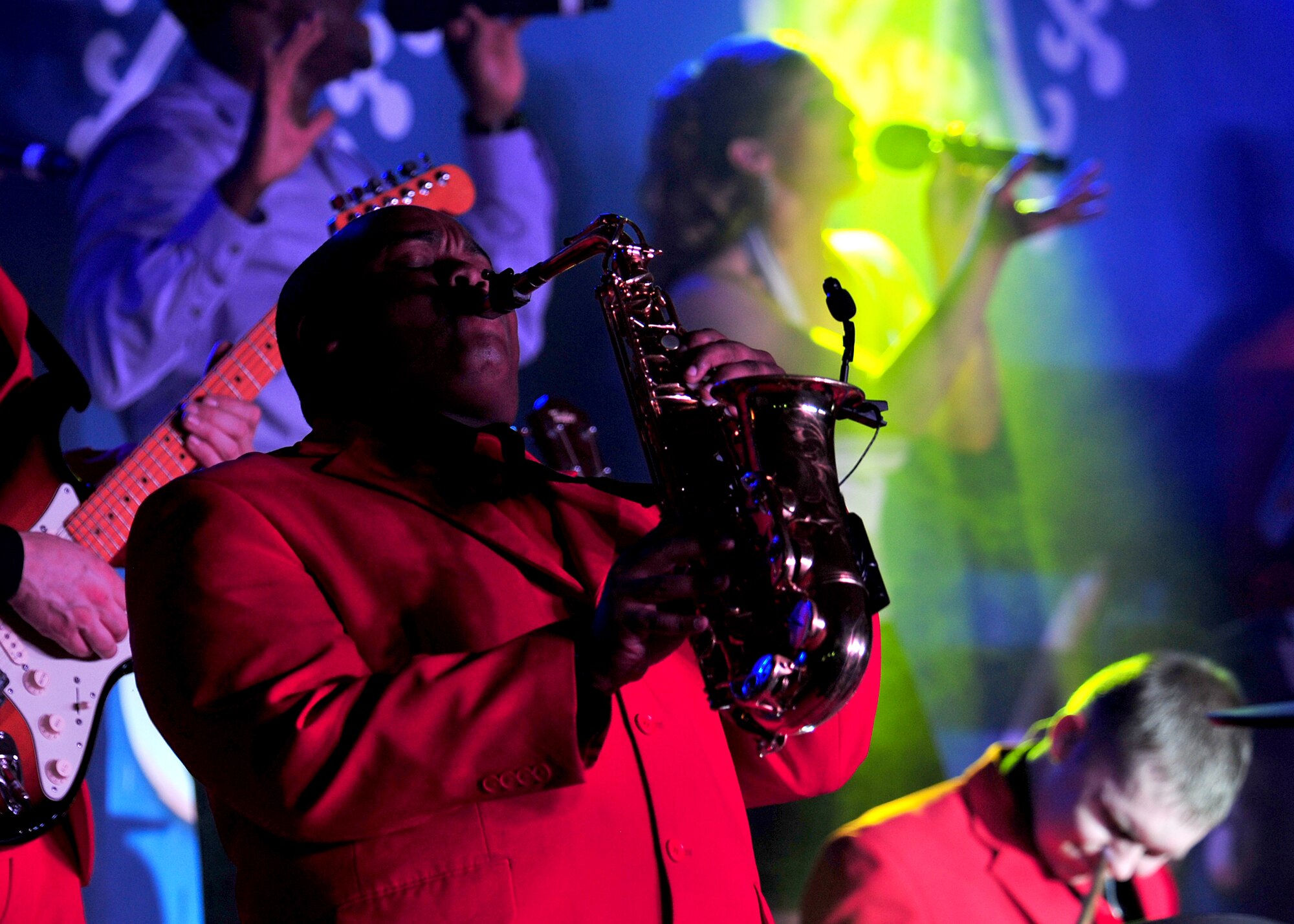 Tigh Lewis, saxophonist, performs a 'Gift of Music' with the Air Force Entertainment Group at an undisclosed location in Southwest Asia, Dec. 19, 2013. Lewis is a native of Houston, Texas, and was a saxophone player during the 2009 Tops in Blue World Tour. (U.S. Air Force photo by Staff Sgt. Michael Means/Released)