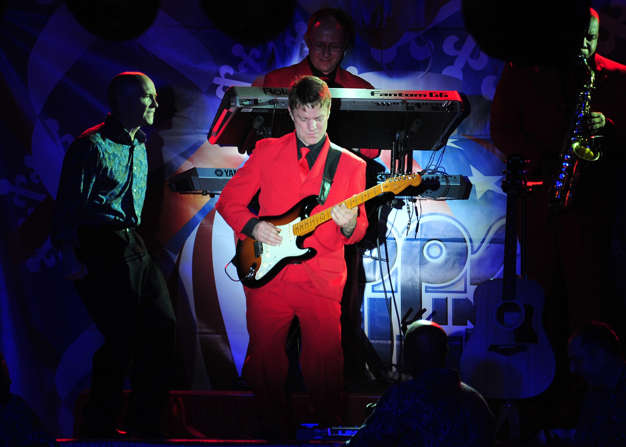 Scott Sutherland, a guitarist for the 'Gift of Music' tour with the Air Force Entertainment Group, performs for the 380th Air Expeditionary Wing at an undisclosed location in Southwest Asia, Dec. 19, 2013. Sutherland toured with Tops in Blue in 1996 and 1997. (U.S. Air Force photo by Staff Sgt. Michael Means/Released)