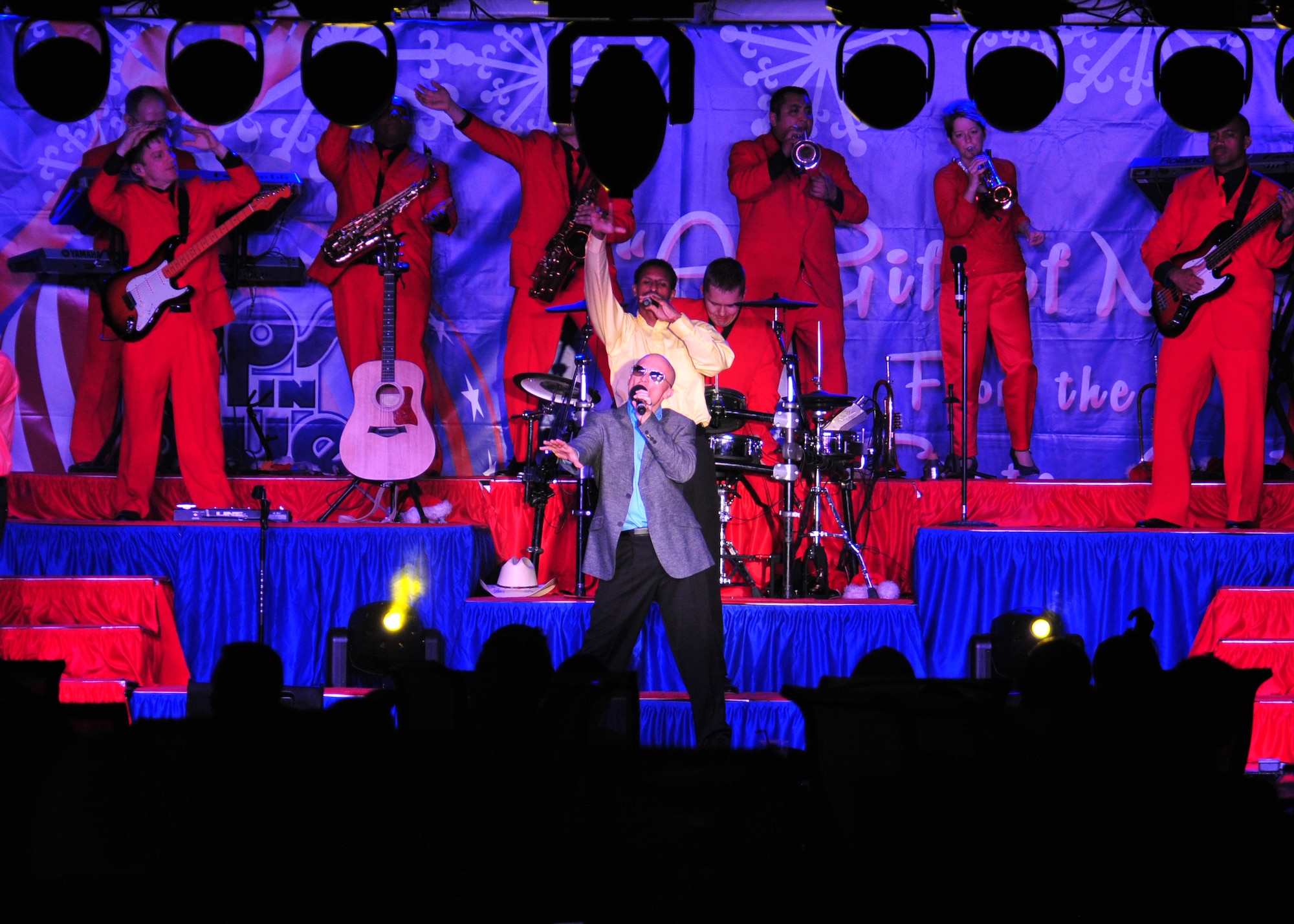 Staff Sgt. Jeffrey Collins, vocalist for the 'Gift of Music' tour with the Air Force Entertainment Group, sings during a performance for the 380th Air Expeditionary Wing at an undisclosed location in Southwest Asia, Dec. 19, 2013. Collins is a broadcaster with the Air Force Reserves at March Air Force Base, Calif. (U.S. Air Force photo by Staff Sgt. Michael Means/Released)