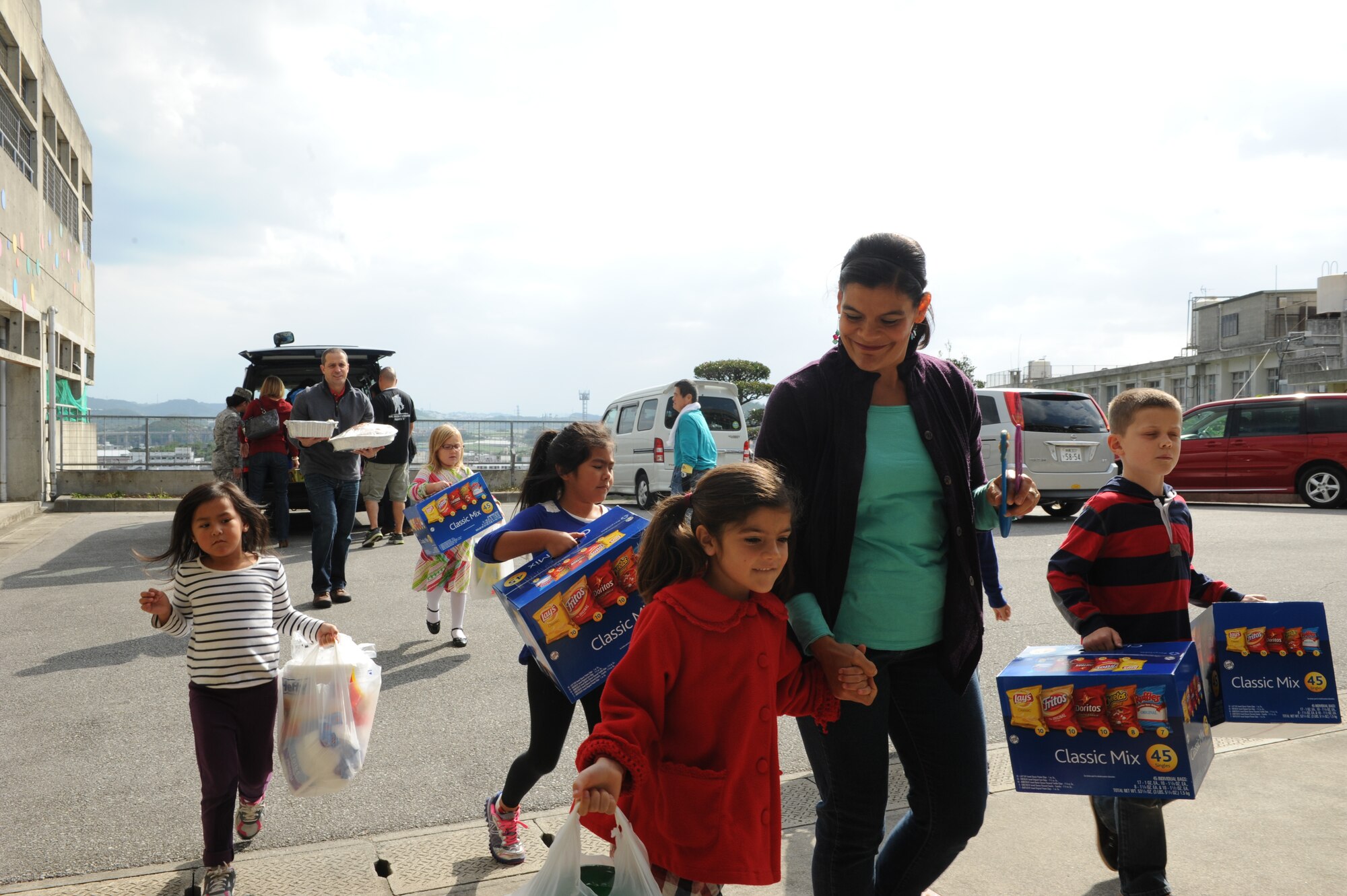 Members of Kadena Air Base bring food and gifts to the Okinawa Chuo Ikusei En facility for special needs for a Christmas Drive on Okinawa, Japan, Dec. 20, 2013. Five turkeys, mashed potatoes, gravy, chips and sodas, along with presents were donated to more than 130 members with special needs during the Christmas drive. (U.S. Air Force photo by Airman 1st Class Hailey R. Staker)