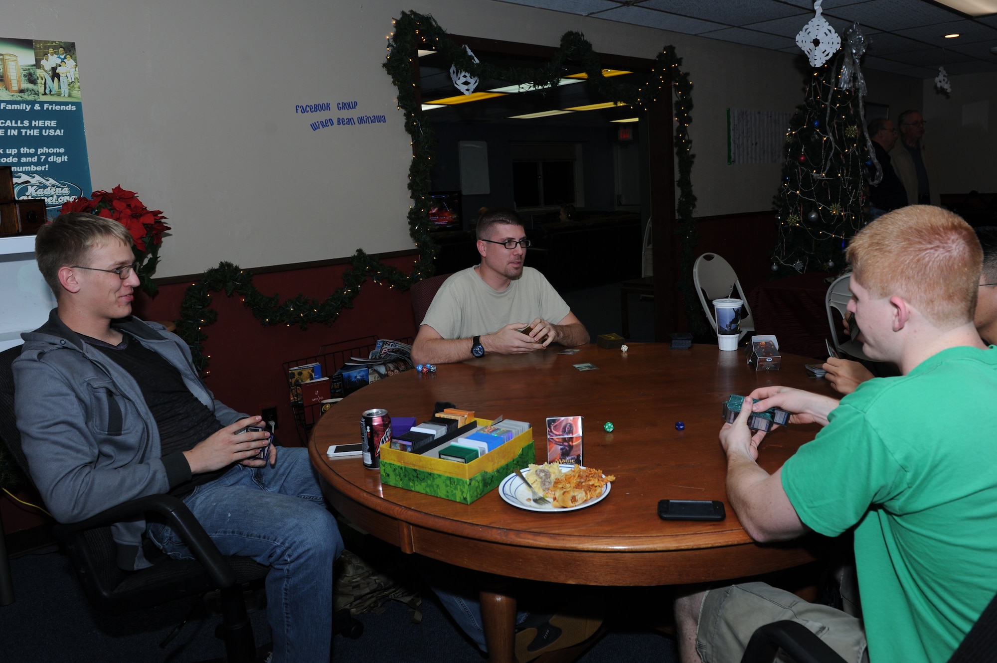 Airmen at the Wired Bean play a card game during Ohana night on Kadena Air Base, Japan, Dec. 19, 2013. The Wired Bean is a chapel-run, community sponsored facility that is open to all service members E-4 and below, and is open 24/7 Dec. 20, 2013 through Jan. 1, 2014. (U.S. Air Force photo by Airman 1st Class Hailey R. Staker)