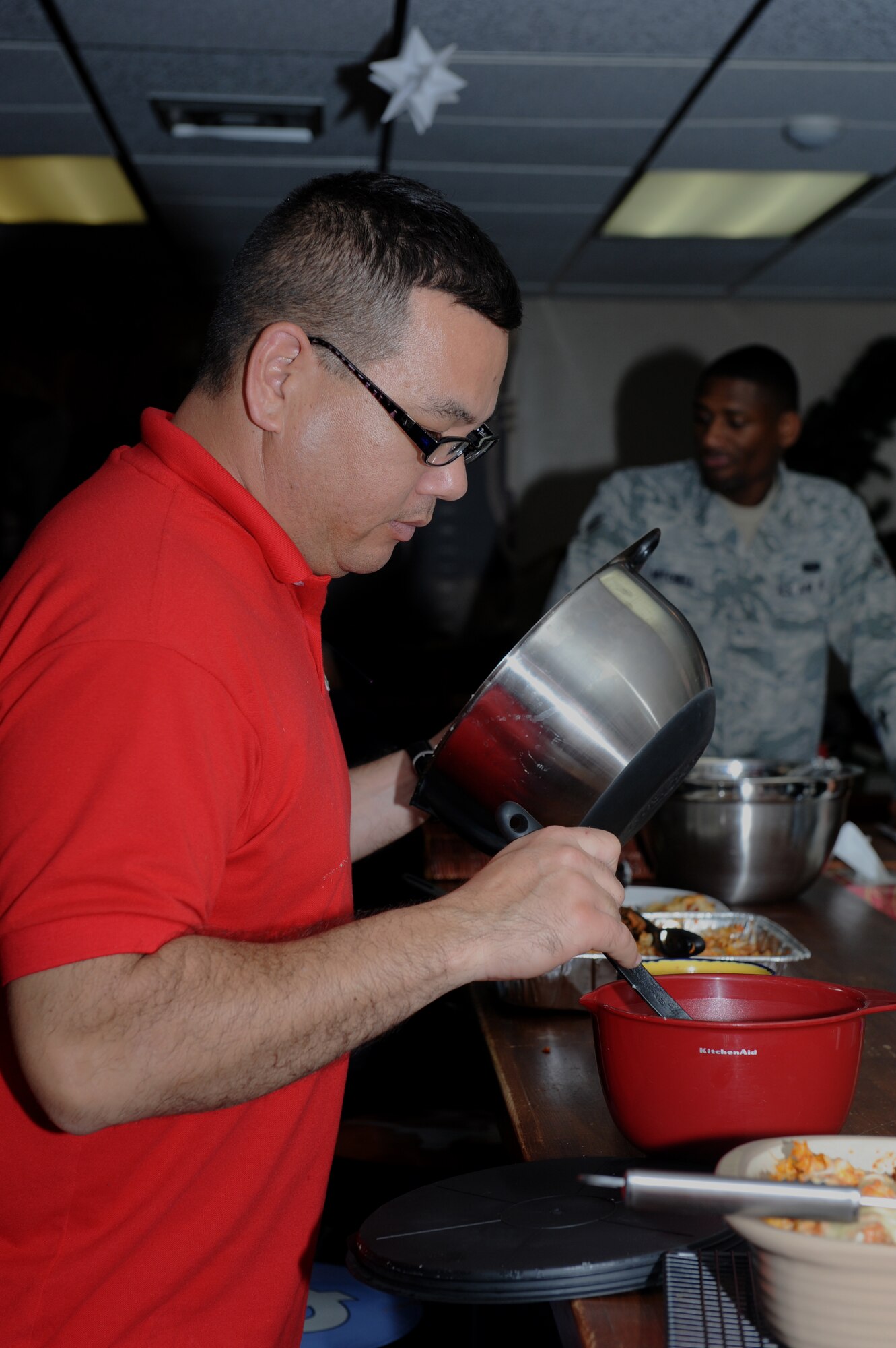 U.S. Air Force Capt. Craig Nakagawa, 18th Wing Chaplain Corps chaplain, prepares a meal during Ohana night at the Wired Bean on Kadena Air Base, Japan, Dec. 19, 2013. Ohana night is one of many activities offered by the Wired Bean where volunteers cook a homemade meal every Thursday and spend an evening with service members each week. (U.S. Air Force photo by Airman 1st Class Hailey R. Staker)

