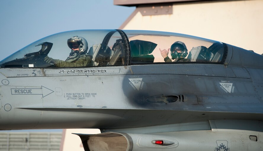 Lt. Col. Erik Bruce, 8th Security Forces Squadron commander, right, gives a “push it up” sign after a familiarization flight at Kunsan Air Base, Republic of Korea, Dec. 18, 2013. Familiarization flights let personnel other than aircrew experience the Air Force’s flying mission first-hand, giving them a better perspective on aerial operations and how their job impacts the flying mission.  (U.S. Air Force photo by Senior Airman Armando A. Schwier-Morales)