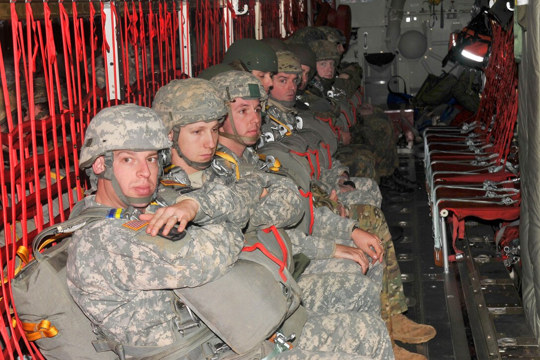U.S., German and French paratroopers ride inside a C-130 Hercules aircraft while conducting an airborne operation in Kaiserslautern, Germany, Dec. 17, 2013. The soldiers are assigned to the 21st Theater Sustainment Command's 5th Quartermaster Detachment.