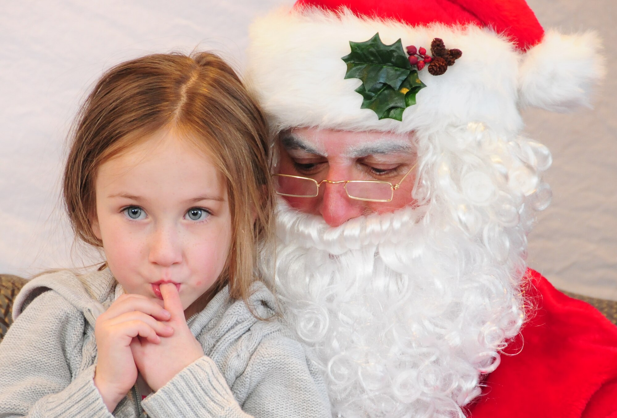 Reagan, 4, isn't sure what she wants to ask Santa Claus for Christmas during the 310th Space Wing Junior Enlisted Council-sponsor "Breakfast with Santa" event Dec. 14 at Peterson Air Force Base, Colo. The event included the breakfast, pictures with Santa, a magic show and balloon animals for families apart of the Exceptional Family Member Program. Reagan is the daughter of Capt. Kenny Grosselin, the 50th Operations Group chief of evaluations. (U.S. Air Force photo/Tech. Sgt. Stephen J. Collier)