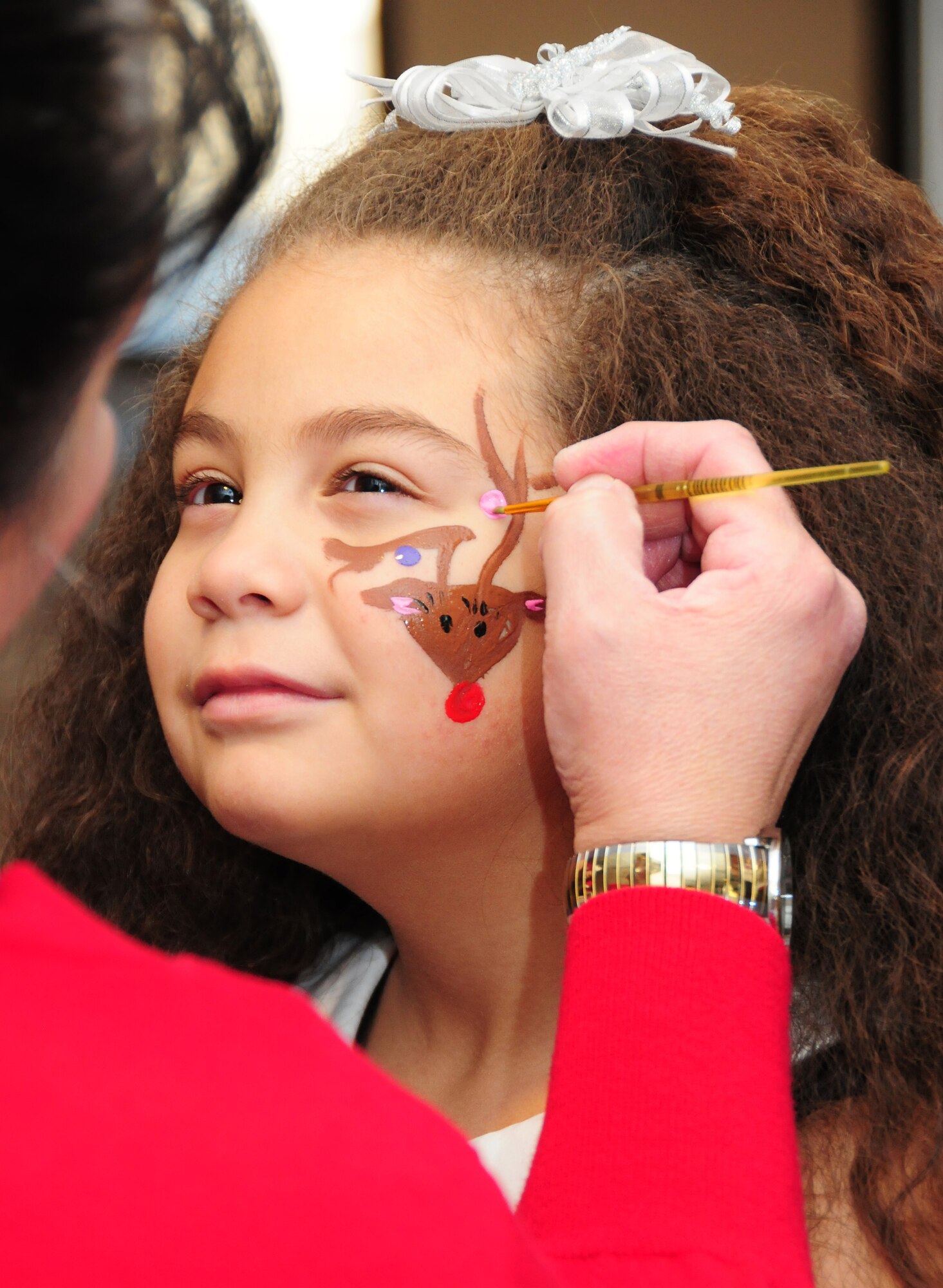 Lilianna shows off her "reindeer" spirit with some face paint during the 310th Space Wing Junior Enlisted Council-sponsor "Breakfast with Santa" event Dec. 14 at Peterson Air Force Base, Colo. The event included the breakfast, pictures with Santa, a magic show and balloon animals for families apart of the Exceptional Family Member Program. Lilianna is the daughter of Master Sgt. Edward, assigned to the Peterson-based Area Dental Lab. (U.S. Air Force photo/Tech. Sgt. Stephen J. Collier)