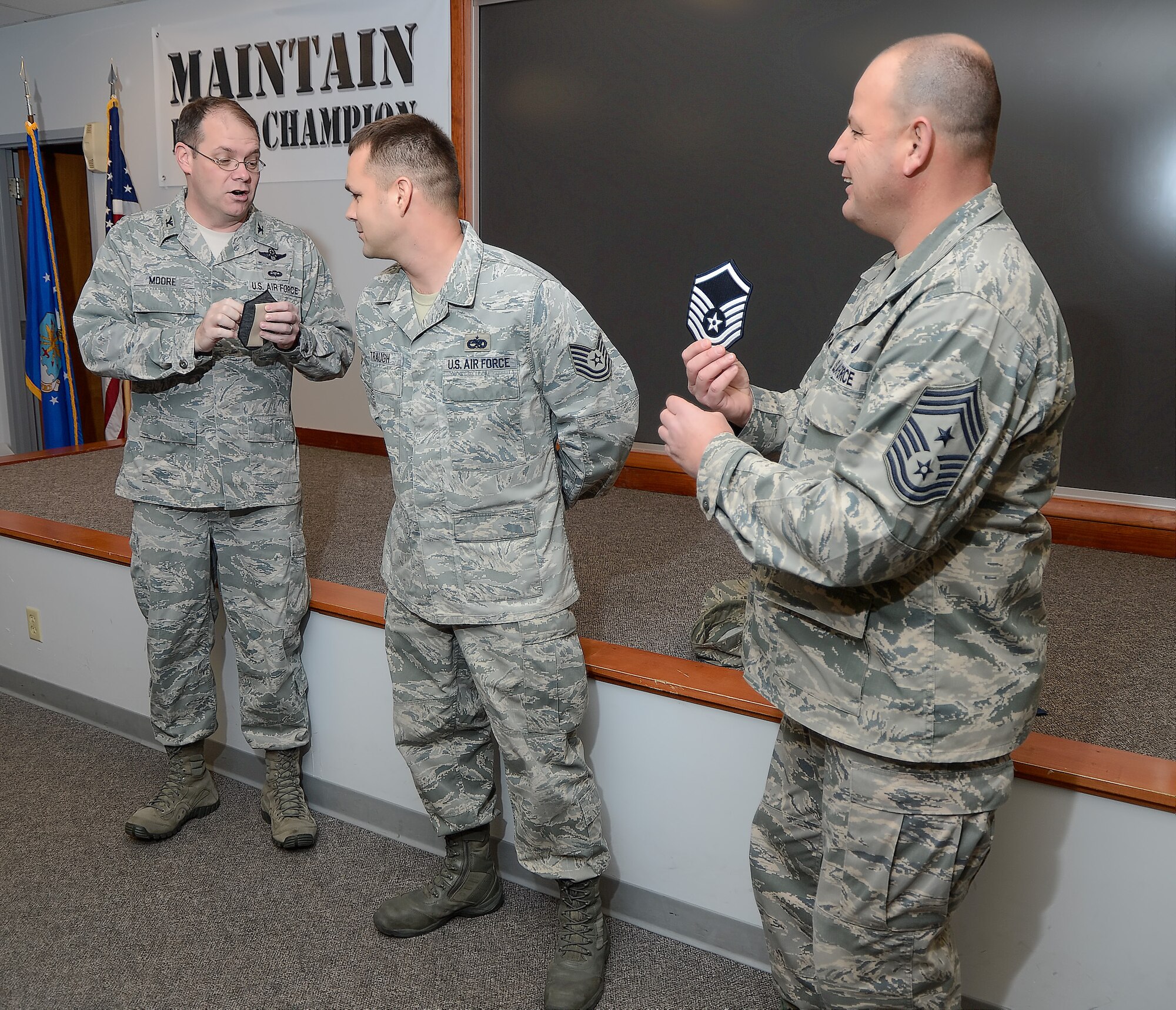 Master Sgt. Heath D. Traugh, 436th Aircraft Maintenance Squadron, receives the news that he has just been step promoted on Dec. 24, 2013, by Colonel Rick Moore (left) and Chief Master Sgt. Jim Smith at Dover Air Force Base, Del. Traugh is a dedicated crew chief for the C-5M Super Galaxy aircraft. (U.S. Air Force photo/Greg L. Davis)