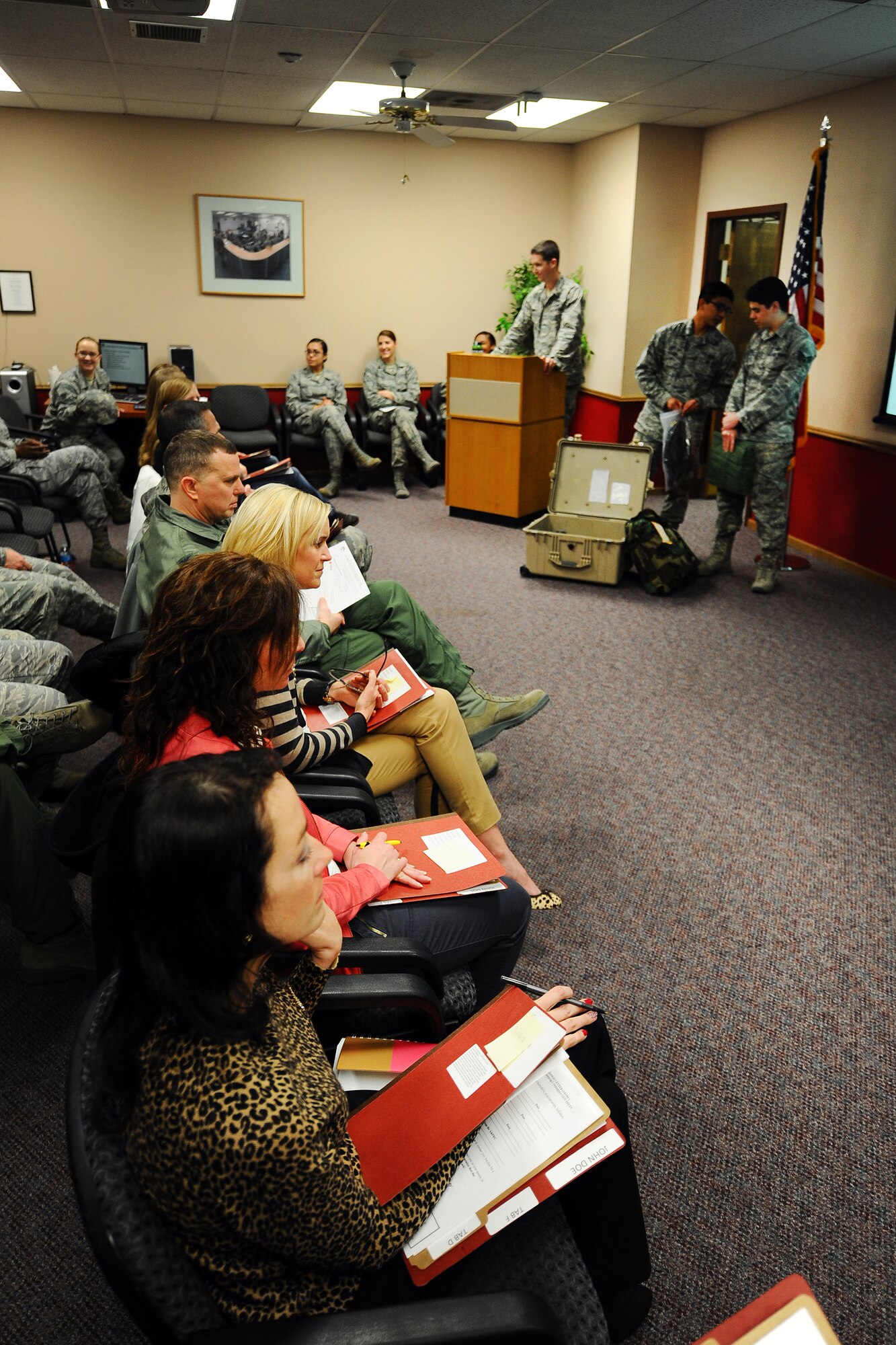 Offutt Key Spouses sit through a mock deployment briefing held at the Mobility Processing Center on Dec. 19 at Offutt Air Force Base, Neb. Key spouses were provided a behind the scenes look at what it takes to get Airman ready to deploy at the event. (U.S. Air Force photo by Josh Plueger/Released)