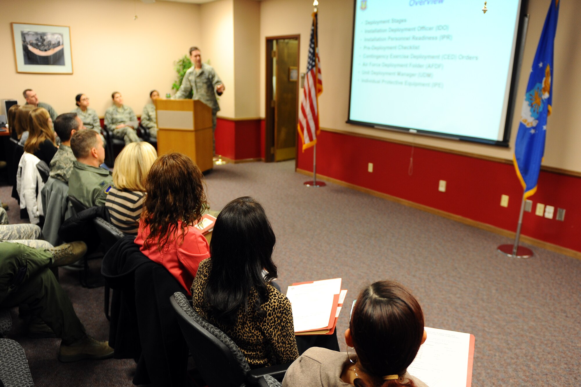 U.S. Air Force 2nd Lt. Quinn Lowry, an installation deployment officer with the 55th Logistics Readiness Squadron, gives a mock deployment briefing to Offutt Key Spouses at the Mobility Processing Center on Dec. 19 at Offutt Air Force Base, Neb.  The event afforded the key spouses an opportunity to see how the deployment process looks from the Airman’s perspective.  (U.S. Air Force photo by Josh Plueger/Released)