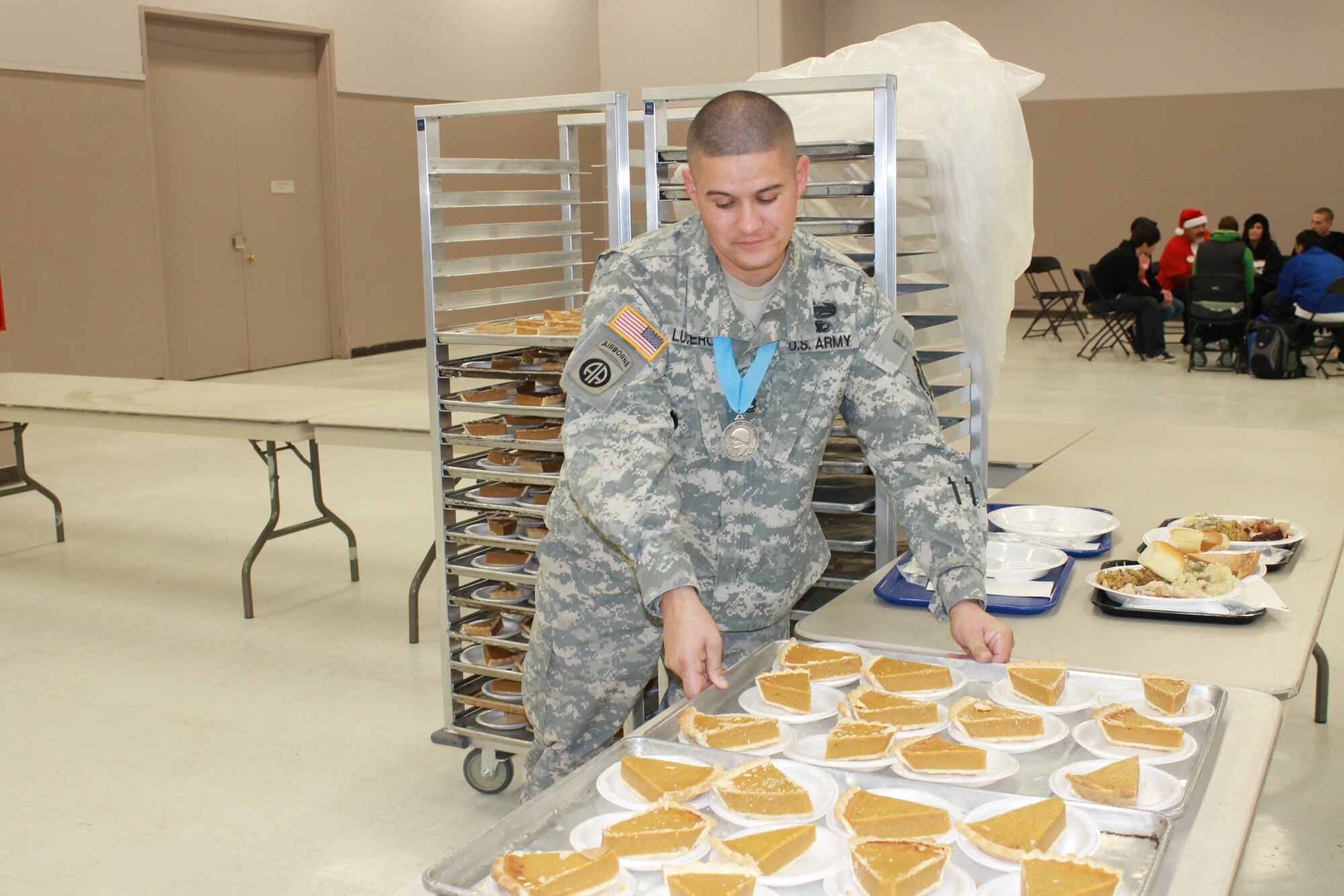 On Dec. 20, Albuquerque Military Entrance and Processing Station staff members volunteered at Joy Junction, New Mexico’s largest homeless shelter. The event at the Albuquerque Convention Center fed approximately 1,500 homeless and hungry people from across the metro area. Army Sgt. 1st Class Martin Lucero, MEPS Human Resources Assistant, prepares to serve pumpkin pie to diners.   
