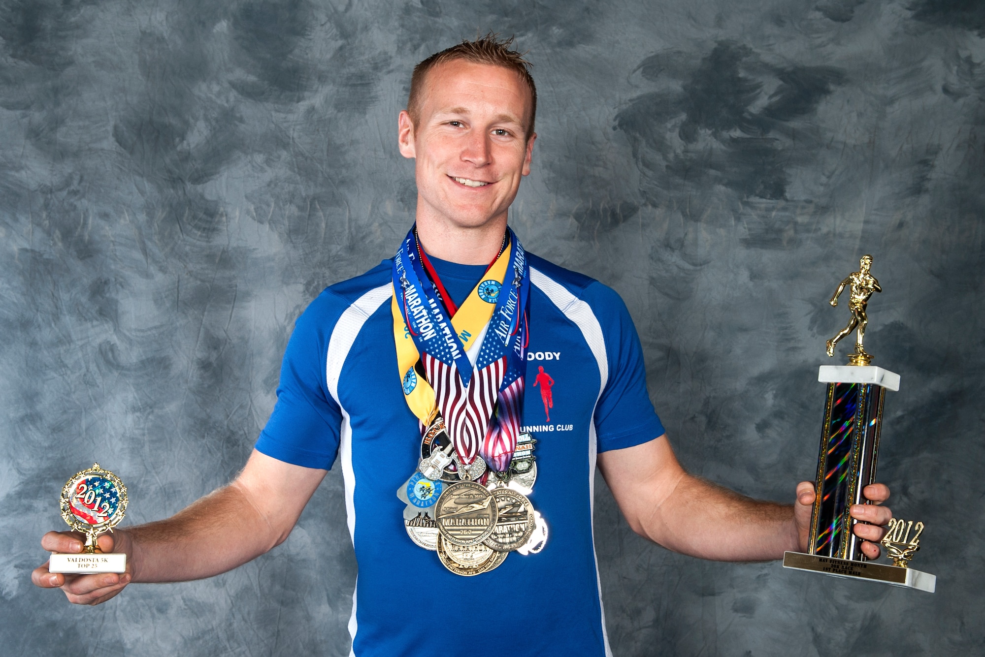 U.S. Air Force Tech. Sgt. Aaron Williams, 372nd Training Squadron Det. 9 instructor, shows off his awards from previous marathons Dec. 23,2013, at Moody Air Force Base, Ga. When training for a race, Williams reserves three days out of the week for long distance runs. (U.S. Air Force photo by Senior Airman Eileen Meier/Released)