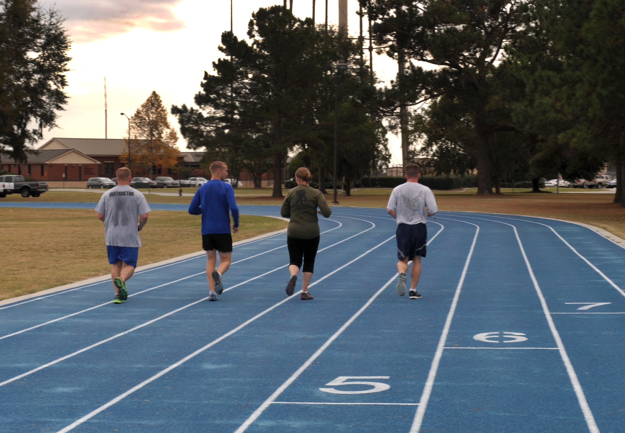 U.S. Air Force Tech. Sgt. Aaron Williams 372nd Training Squadron Det. 9 instructor, and members of the Moody Runners Group complete a cool down lap after a sprint workout at Moody Air Force Base, Ga., Nov. 21, 2013. Williams coordinates a lunchtime run Tuesdays and Thursdays to help others increase speed and stamina. (U.S. Air Force photo by Senior Airman Olivia Bumpers/Released)
