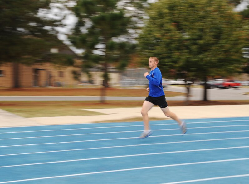 U.S. Air Force Tech. Sgt. Aaron Williams, 372nd Training Squadron Det. 9 instructor, sprints around the running track at Moody Air Force Base, Ga., Nov. 21, 2013. Williams heads the Moody Runner Group and conducts lunch interval and tempo runs every Tuesday and Thursday. (U.S. Air Force photo by Senior Airman Olivia Bumpers/Released)
