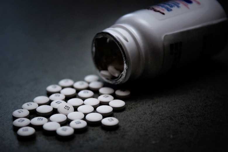 Prescription pain pills are seen dumped out on a table at Grissom Air Reserve Base, Ind. Airmen who take prescription pills that are not their own or are taken after the time allotted could find themselves facing severe discipline. (U.S. Air Force photo illustration/Tech. Sgt. Mark R. W. Orders-Woempner) 