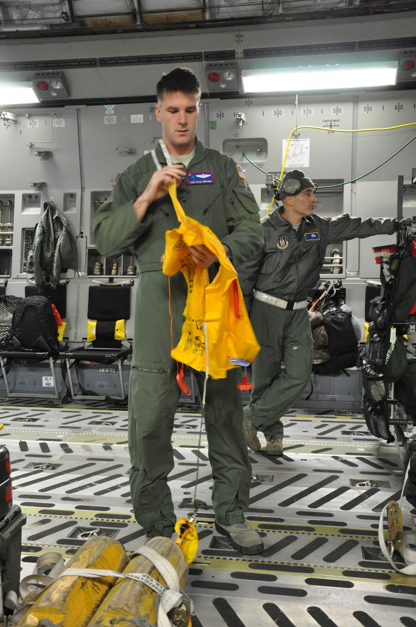 Tech. Sgt. Kyle Simpson, a loadmaster and full-time college student assigned to the 701st Airlift Squadron, Joint Base Charleston, S.C., conducts pre-flight safety instruction aboard a C-17 Globemaster III aircraft prior to departing Incirlik Air Base, Turkey Dec. 22. (U.S. Air Force photo by Senior Airman Bobby Pilch/released)