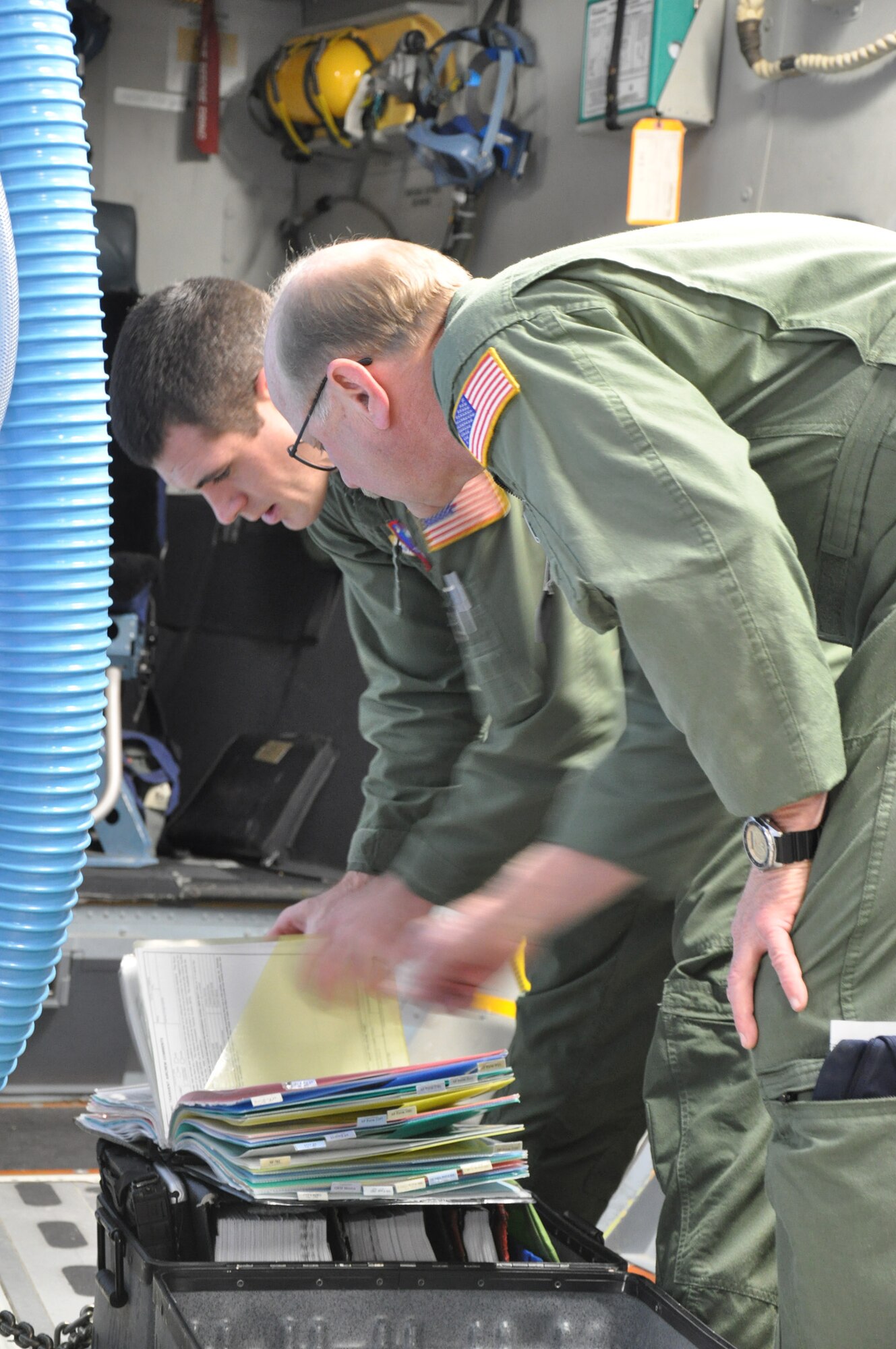 Master Sgt. Dennis Moore (right), an air reserve technician with the 701st Airlift Squadron, Joint Base Charleston, S.C. provides technical instruction to Tech. Sgt. Shayne Katirgis (left), a loadmaster assigned to the 701 AS, during his check ride from Incirlik Air Base, Turkey Dec. 22. (U.S. Air Force photo by Senior Airman Bobby Pilch/released)