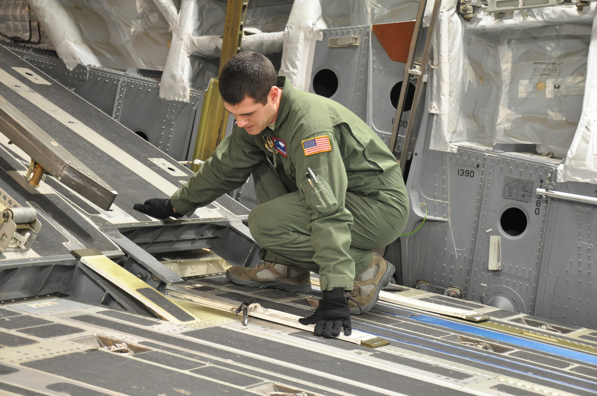 Tech. Sgt. Shayne Katirgis, a loadmaster and full-time college student assigned to the 701st Airlift Squadron, Joint Base Charleston, S.C., prepares the loading ramp on a C-17 Globemaster III aircraft prior to departing Incirlik Air Base, Turkey Dec. 22. (U.S. Air Force photo by Senior Airman Bobby Pilch/released)