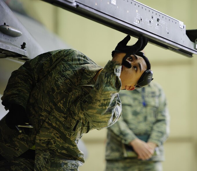 Senior Airman Ryanted Duarte, 80th Aircraft Maintenance Unit, readies an F-16 Fighting Falcon during a quarterly load competition at Kunsan Air Base, Republic of Korea, Dec. 20, 2013. The 8th Maintenance Squadron Weapons Standardization Section hosts load competitions to test the skills learned by Airmen and boost morale.  (U.S. Air Force photo by Senior Airman Armando A. Schwier-Morales/Released)