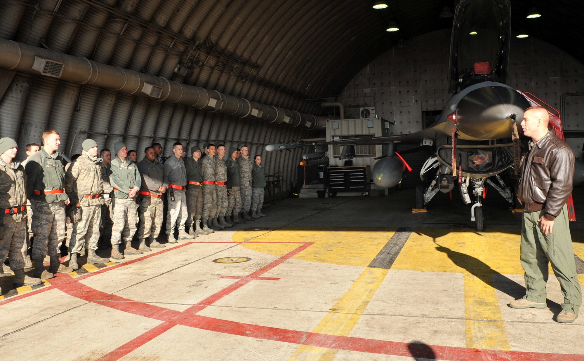 Col. Brook Leonard, 51st Fighter Wing commander, speaks to Airmen from the 36th Fighter Squadron and 36th Aircraft Maintenance Unit on the flight line at Osan Air Base, Republic of Korea, Dec. 23, 2013. Leonard wished the Airmen a happy holiday season and thanked them for their hard work year round. (U.S. Air Force photo/Airman 1st Class Ashley J. Thum)