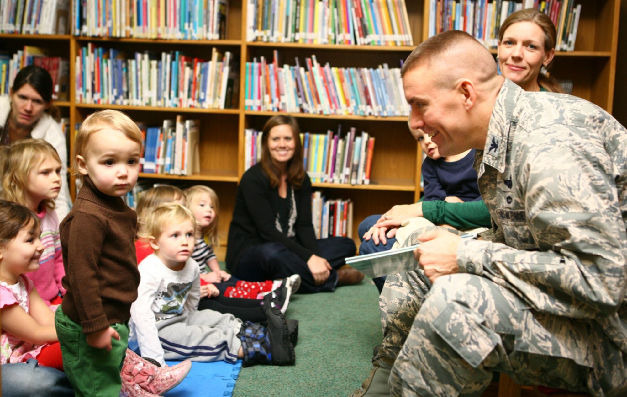 Col. Brook Leonard, 51st Fighter Wing commander, interacts with an Osan child during a story time event as part of the 51st Force Support Squadron’s “12 Days of Customer Appreciation” in the library at Osan Air Base, Republic of Korea, Dec. 20, 2013. Leonard and his wife, Maria, read holiday-themed books, including “Santa Bear” and “Polar Express,” and sang songs like “12 Days of Christmas.” (U.S. Air Force photo/Airman 1st Class Ashley J. Thum) 