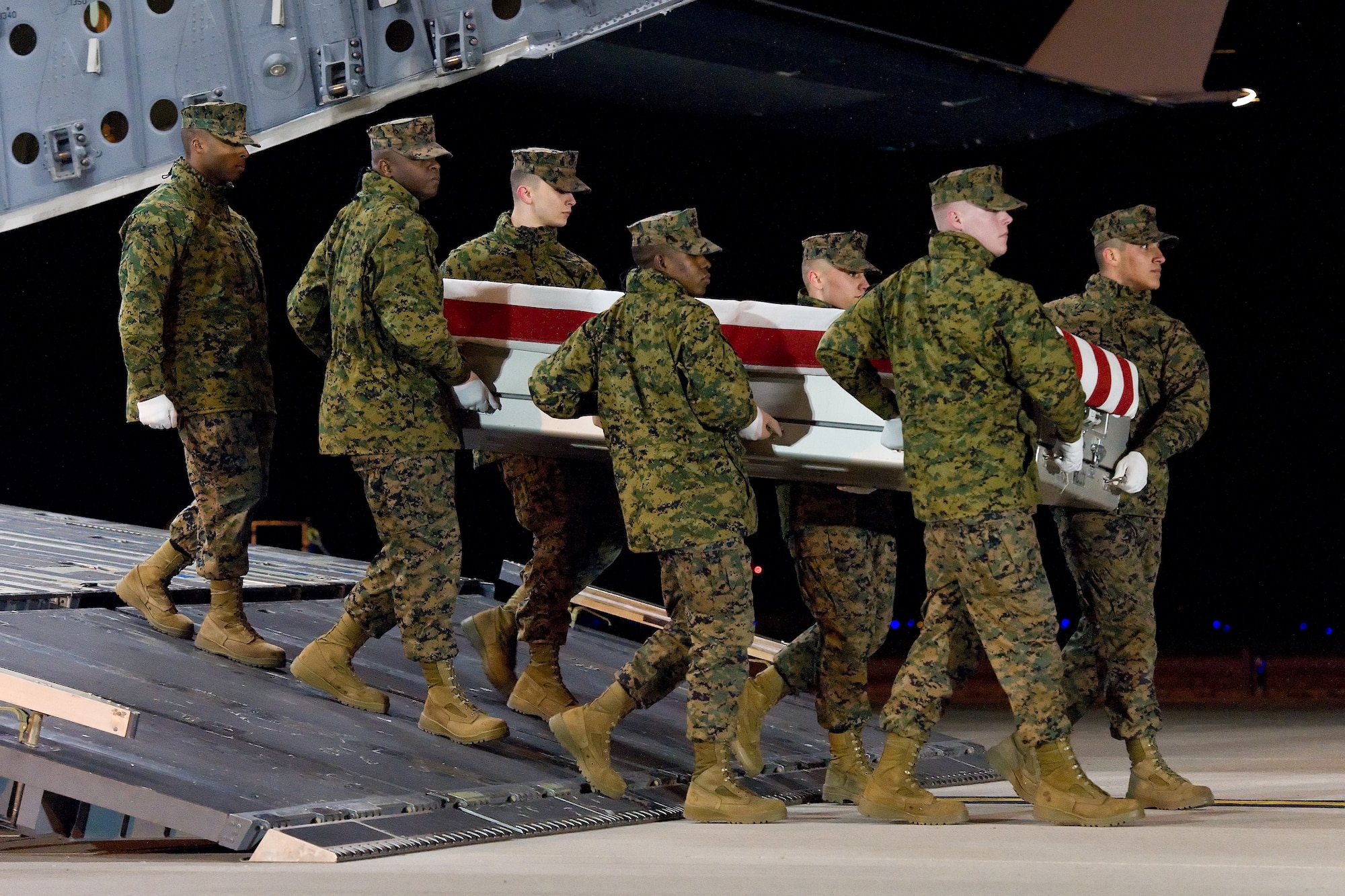 A U.S. Marine Corps carry team transfers the remains of Marine Sgt. Daniel M. Vasselian, of Abington, Mass., at Dover Air Force Base, Del., Dec. 25, 2013. Vasselian was assigned to 1st Battalion, 9th Marine Regiment, 2nd Marine Division, II Marine Expeditionary Force, Camp Lejeune, N.C. (U.S. Air Force photo/Roland Balik)